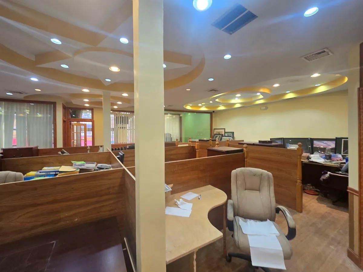 Office space with recessed lighting and wood finished floors Office space with recessed lighting and wood finished floors