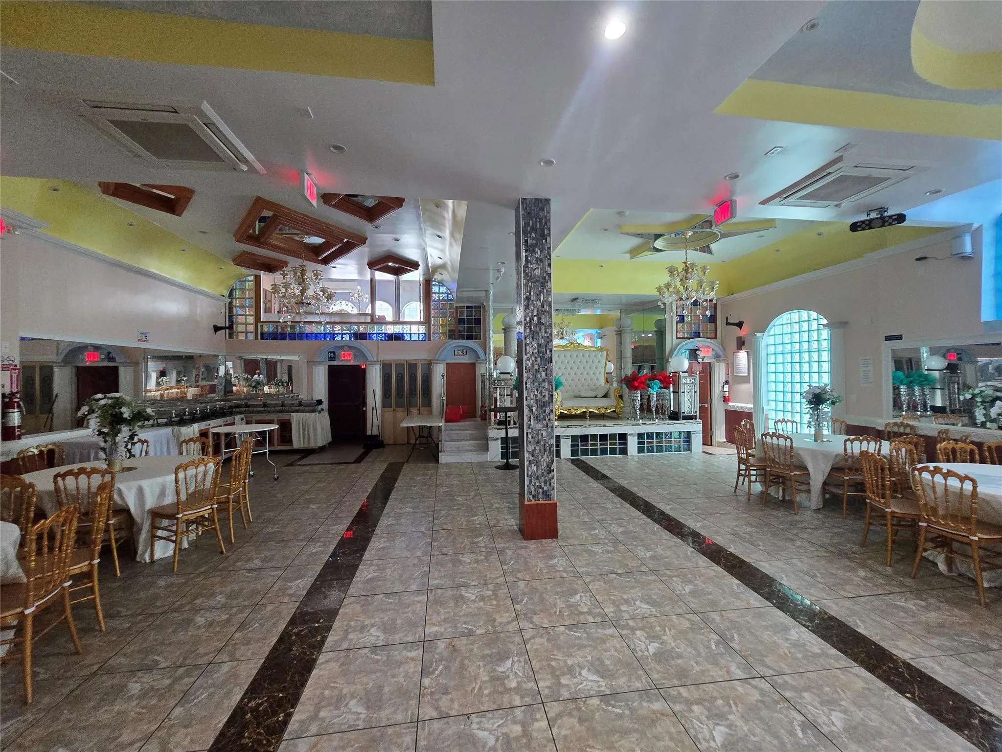 Building lobby featuring a towering ceiling and recessed lighting Building lobby featuring a towering ceiling and recessed lighting