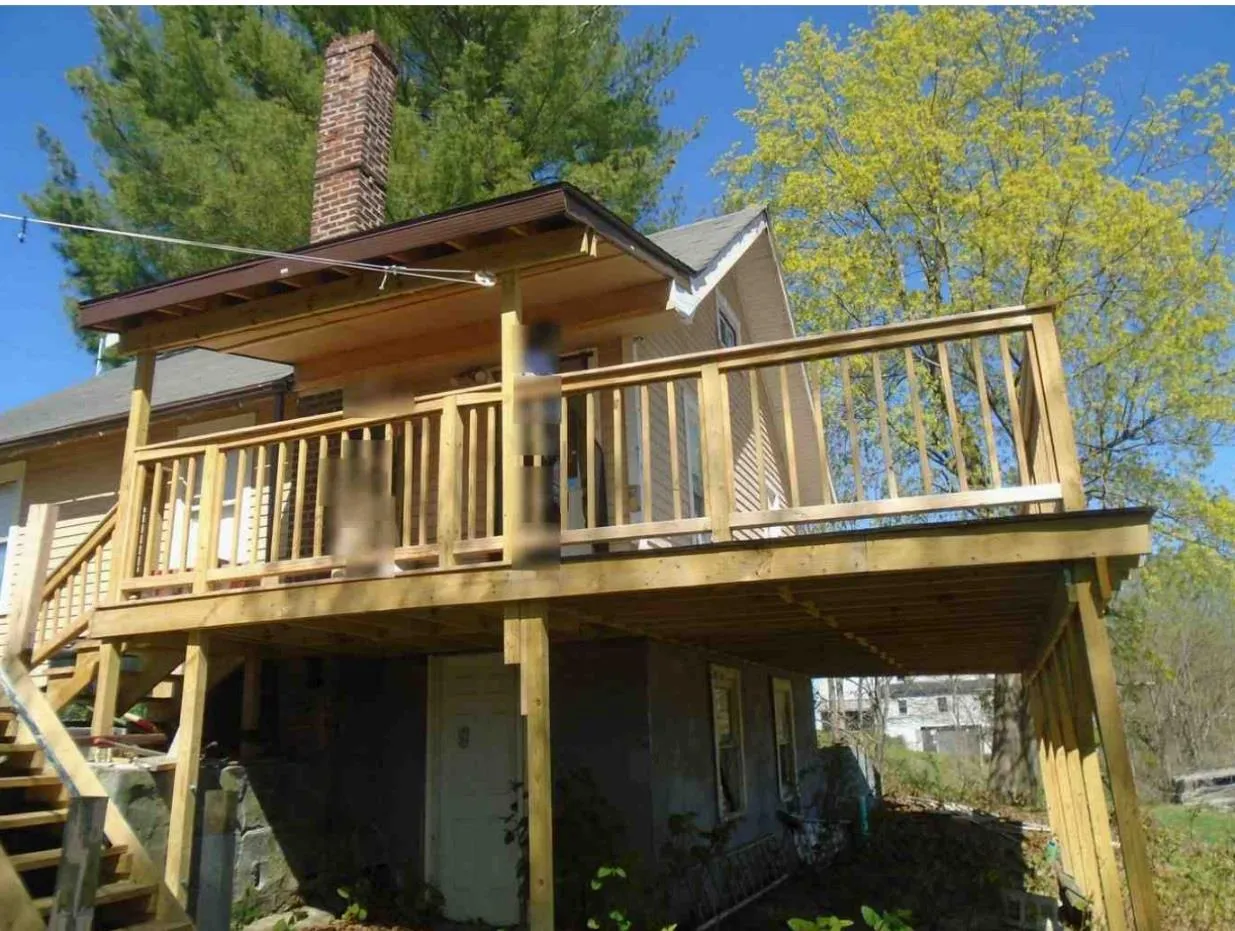 Back of house featuring a wooden deck and stairs Back of house featuring a wooden deck and stairs
