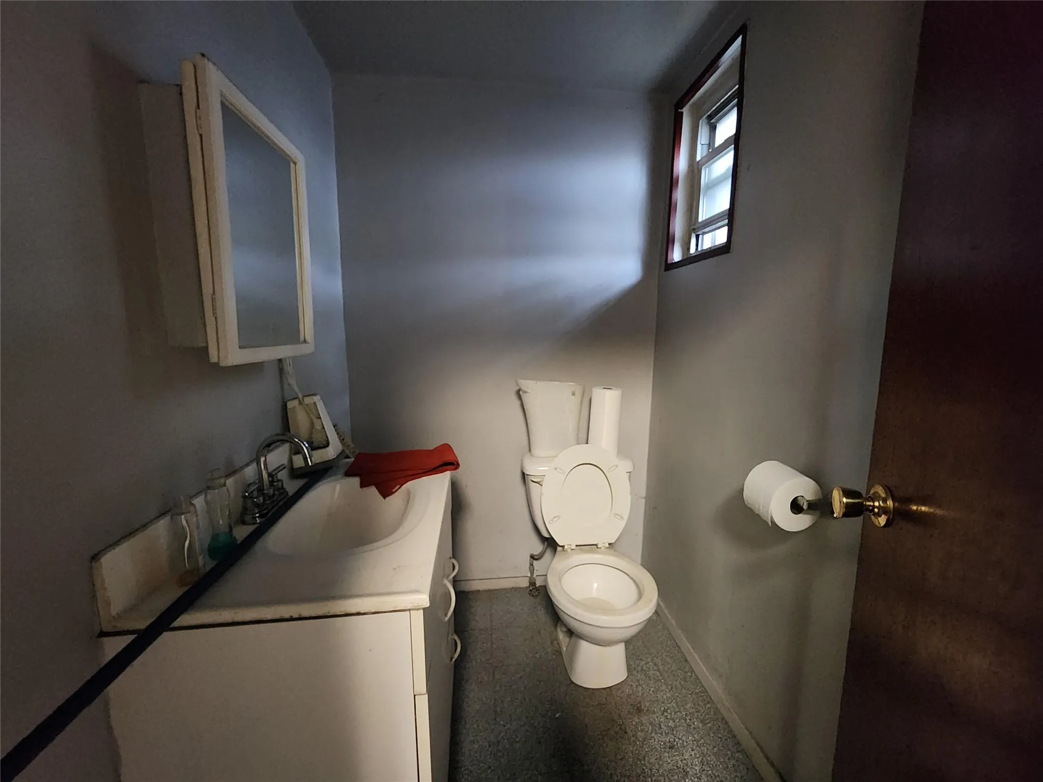 Bathroom featuring toilet, vanity, and baseboards Bathroom featuring toilet, vanity, and baseboards