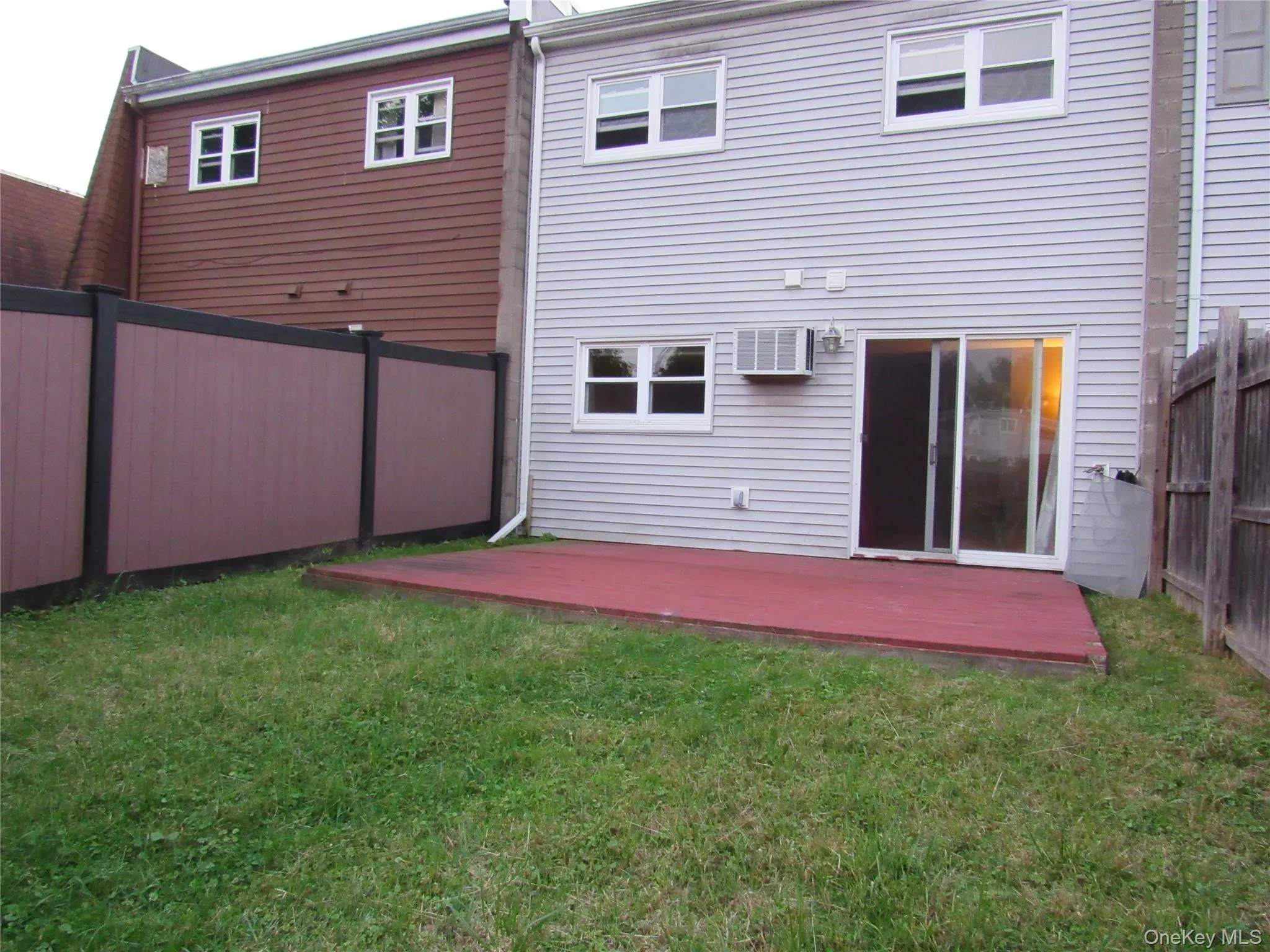 Back of property featuring a wooden deck and a fenced backyard Back of property featuring a wooden deck and a fenced backyard