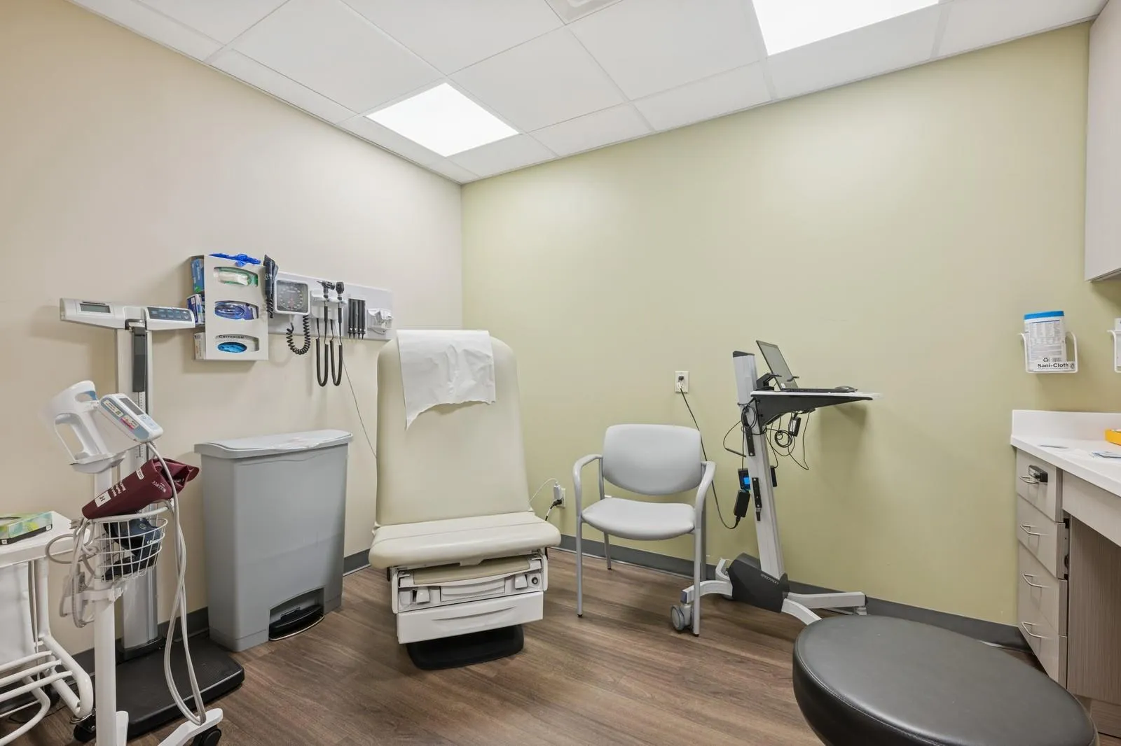 Misc room featuring wood finished floors and a drop ceiling Misc room featuring wood finished floors and a drop ceiling