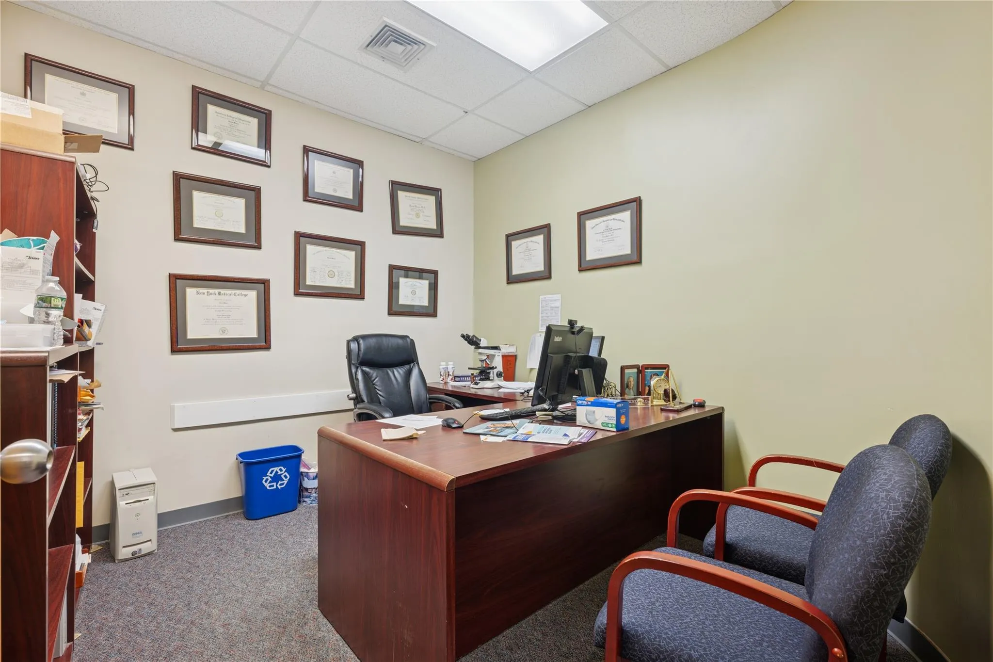 Office area featuring carpet flooring and a paneled ceiling Office area featuring carpet flooring and a paneled ceiling