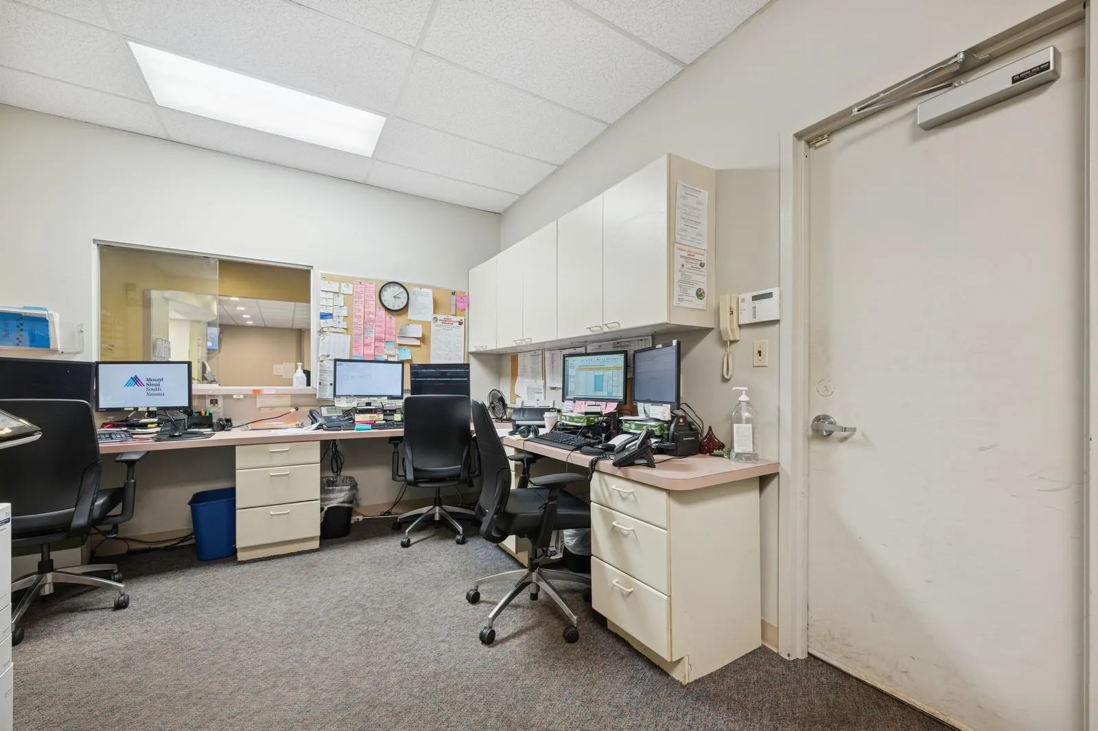 Home office featuring carpet flooring and a drop ceiling Home office featuring carpet flooring and a drop ceiling