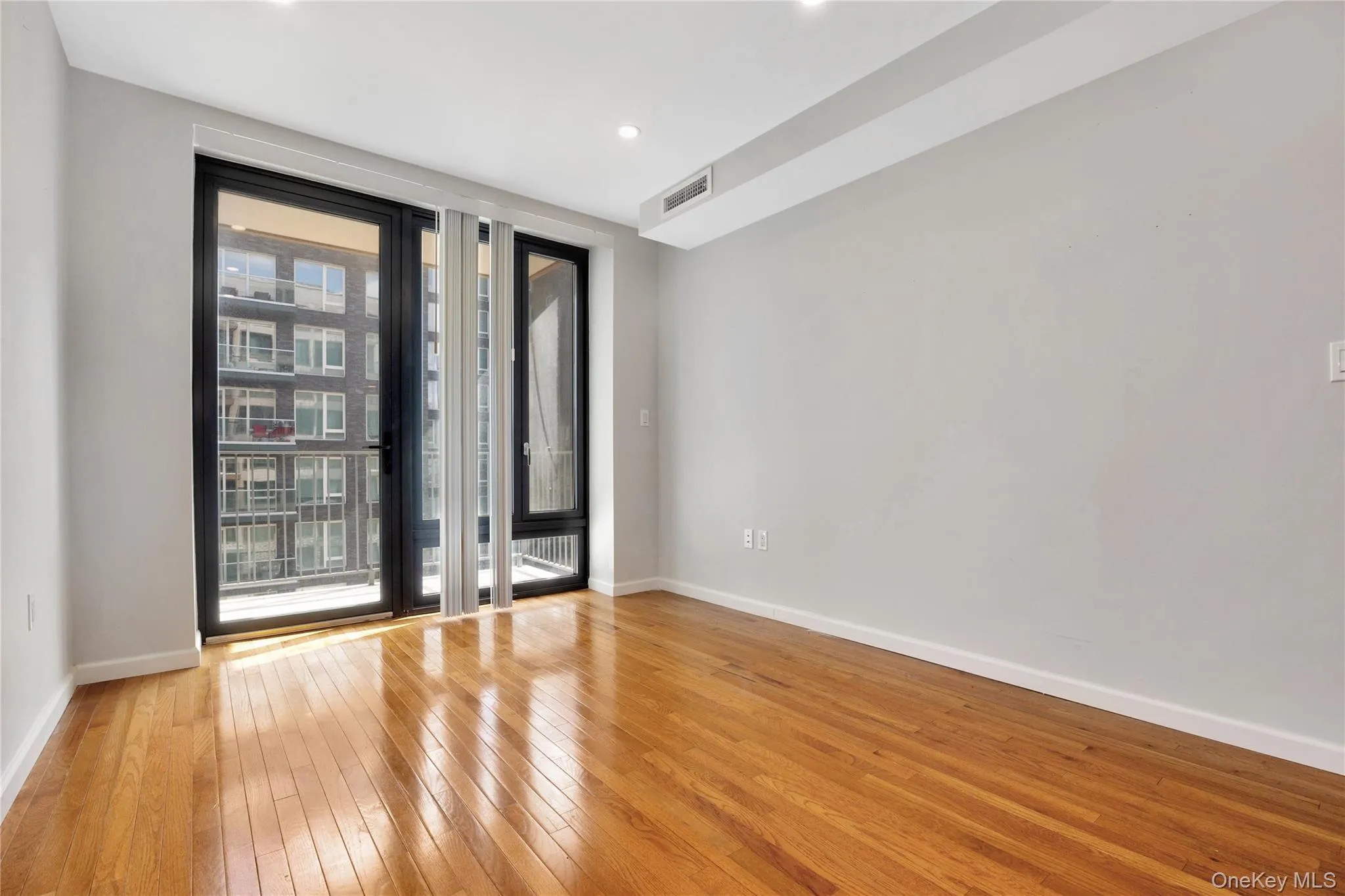 Unfurnished room featuring light wood-type flooring, baseboards, visible vents, and recessed lighting Unfurnished room featuring light wood-type flooring, baseboards, visible vents, and recessed lighting