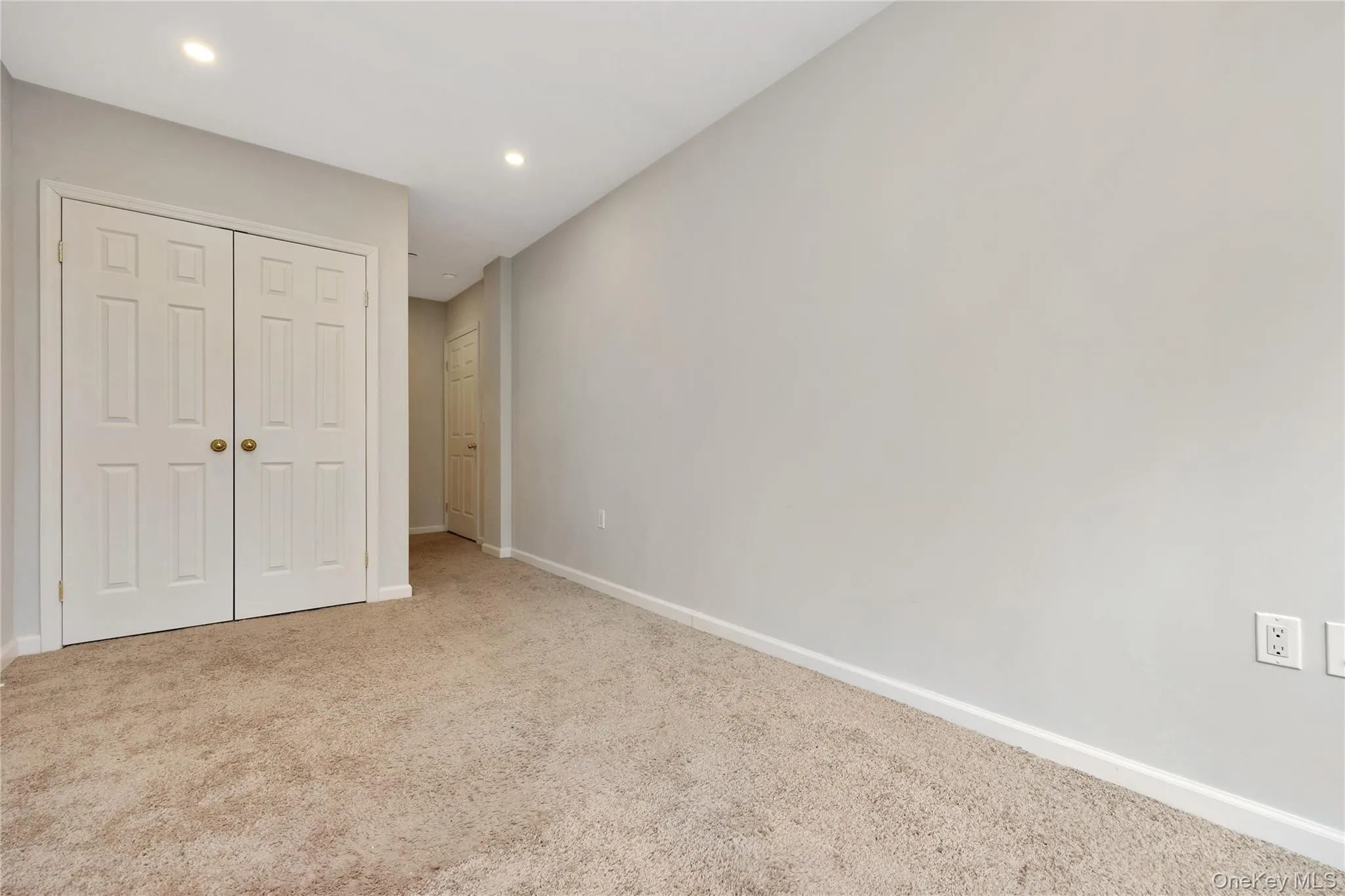 Unfurnished bedroom with a closet, recessed lighting, carpet, and baseboards Unfurnished bedroom with a closet, recessed lighting, carpet, and baseboards