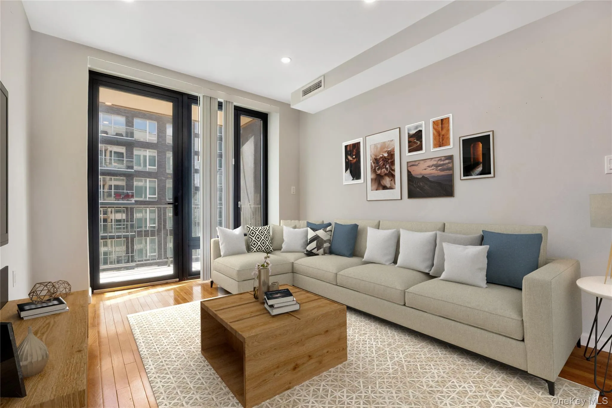 Living area featuring recessed lighting, plenty of natural light, visible vents, and light wood-type flooring Living area featuring recessed lighting, plenty of natural light, visible vents, and light wood-type flooring