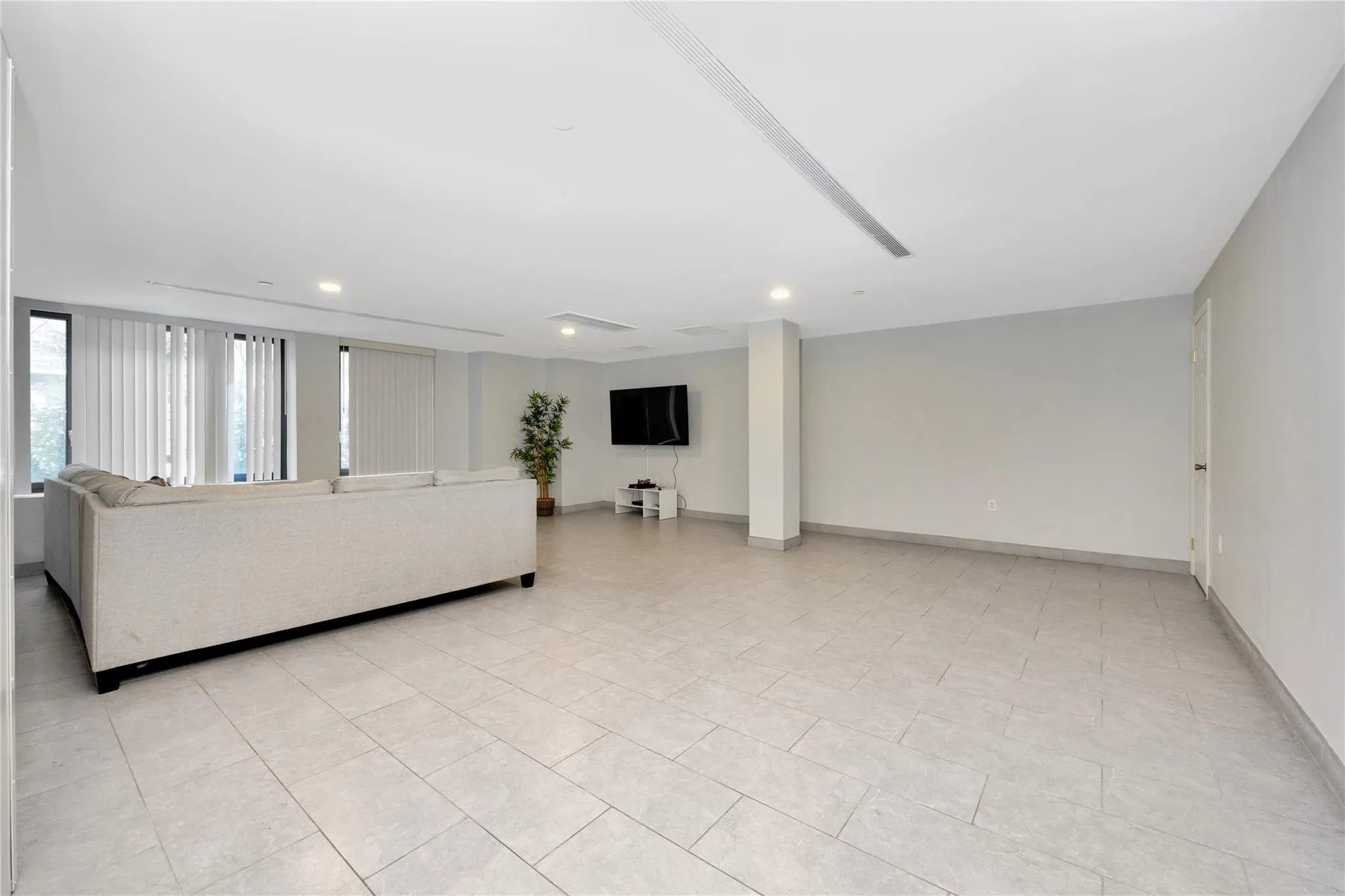 Living room featuring baseboards and recessed lighting Living room featuring baseboards and recessed lighting