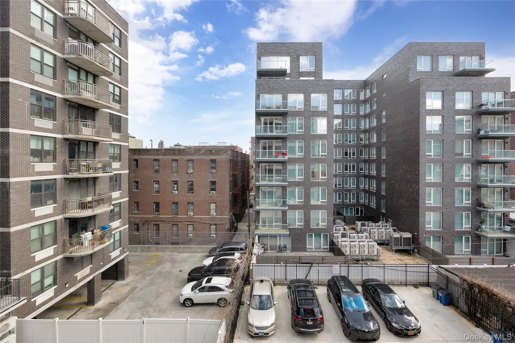 View of building exterior featuring uncovered parking View of building exterior featuring uncovered parking