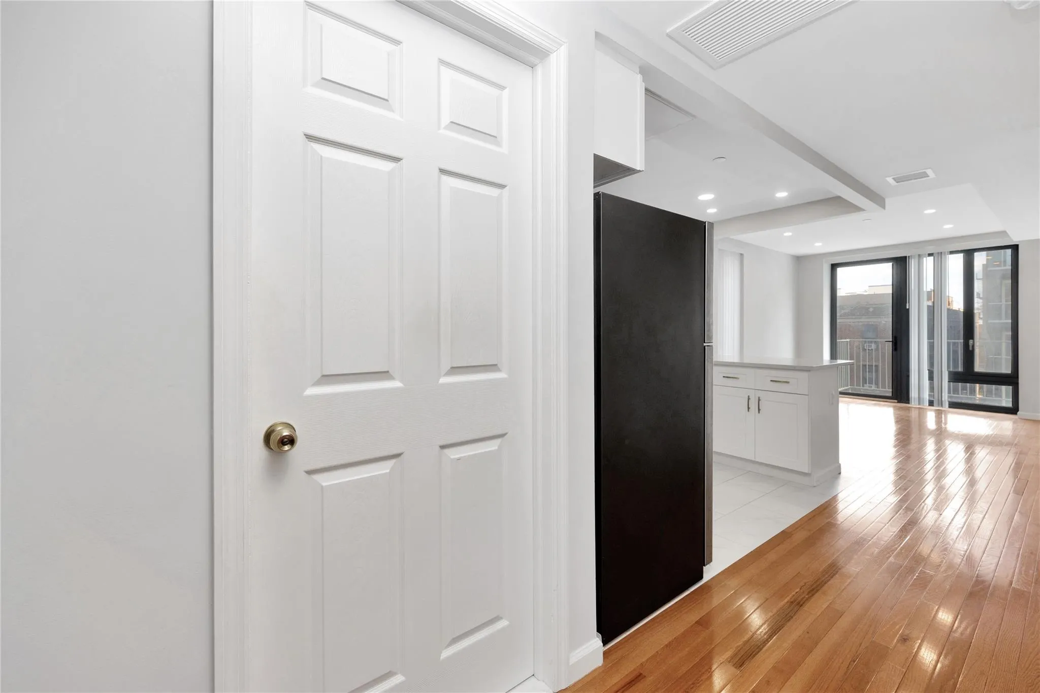 Corridor featuring light wood-type flooring, visible vents, and recessed lighting Corridor featuring light wood-type flooring, visible vents, and recessed lighting