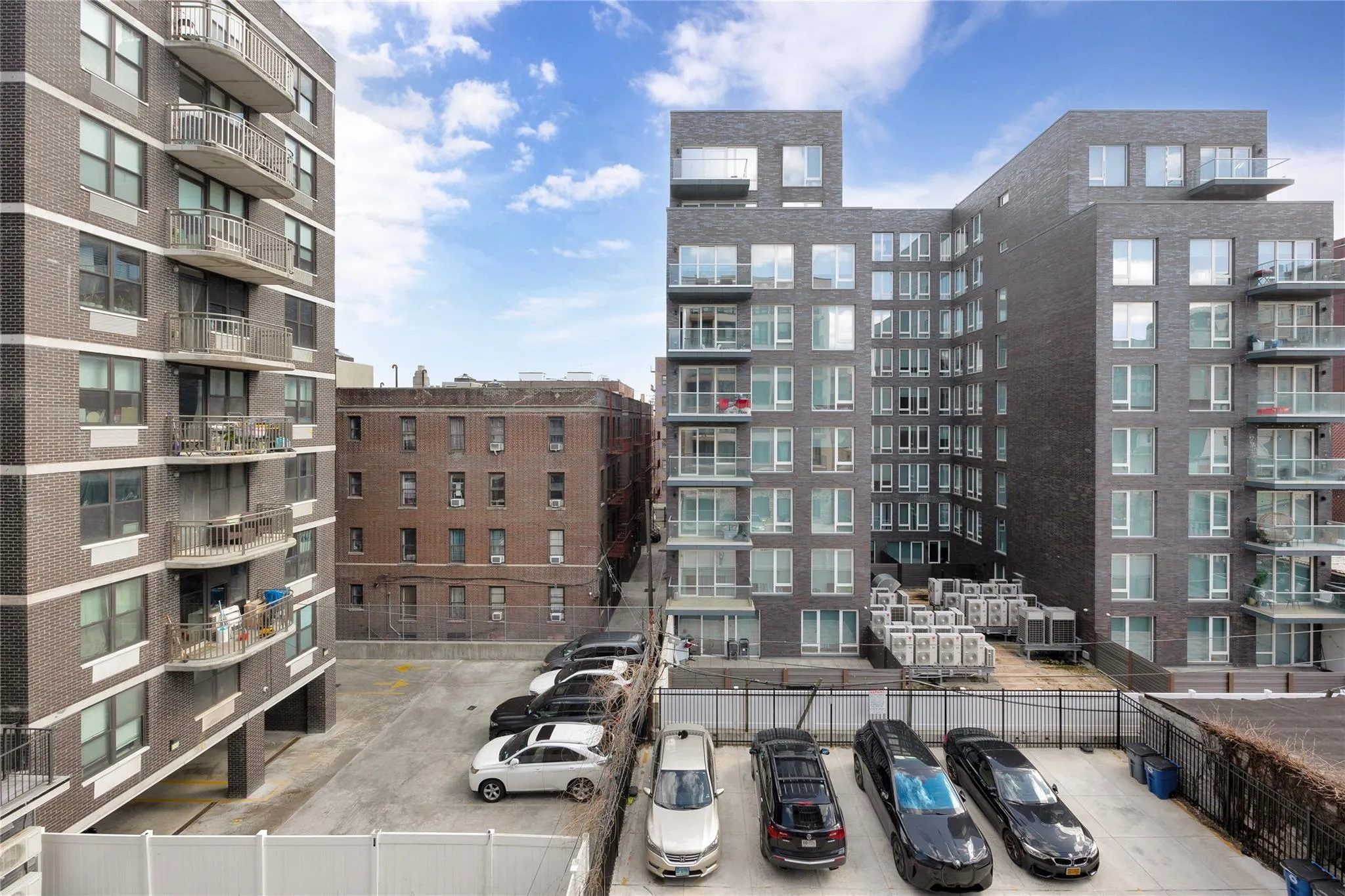 View of building exterior featuring uncovered parking View of building exterior featuring uncovered parking