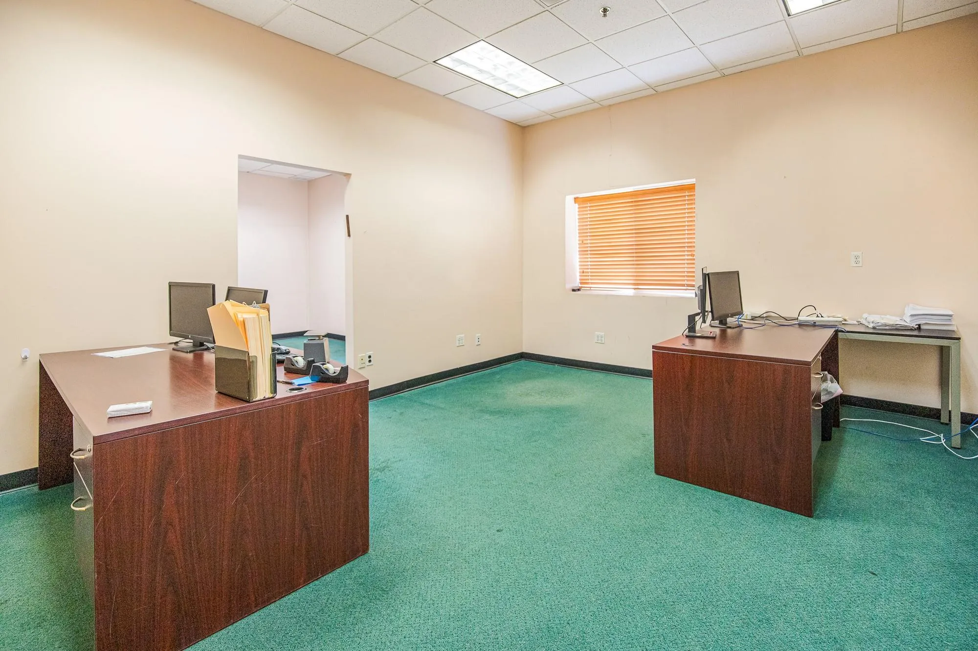 Unfurnished office featuring carpet and baseboards Unfurnished office featuring carpet and baseboards