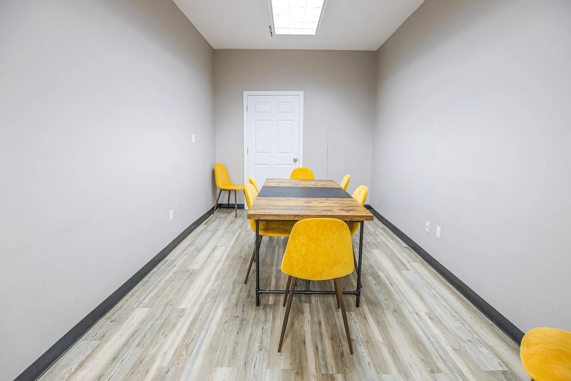 Dining space featuring baseboards and light wood-style floors Dining space featuring baseboards and light wood-style floors