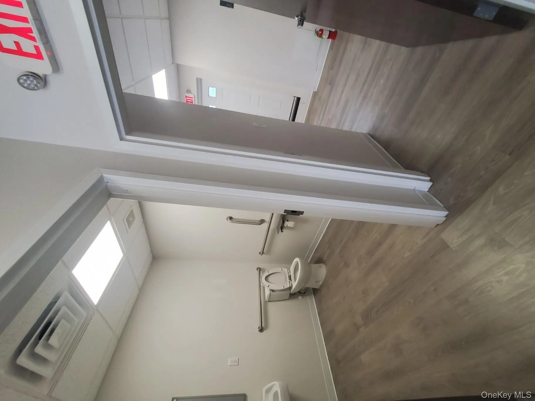 Bathroom with a drop ceiling and dark wood finished floors Bathroom with a drop ceiling and dark wood finished floors