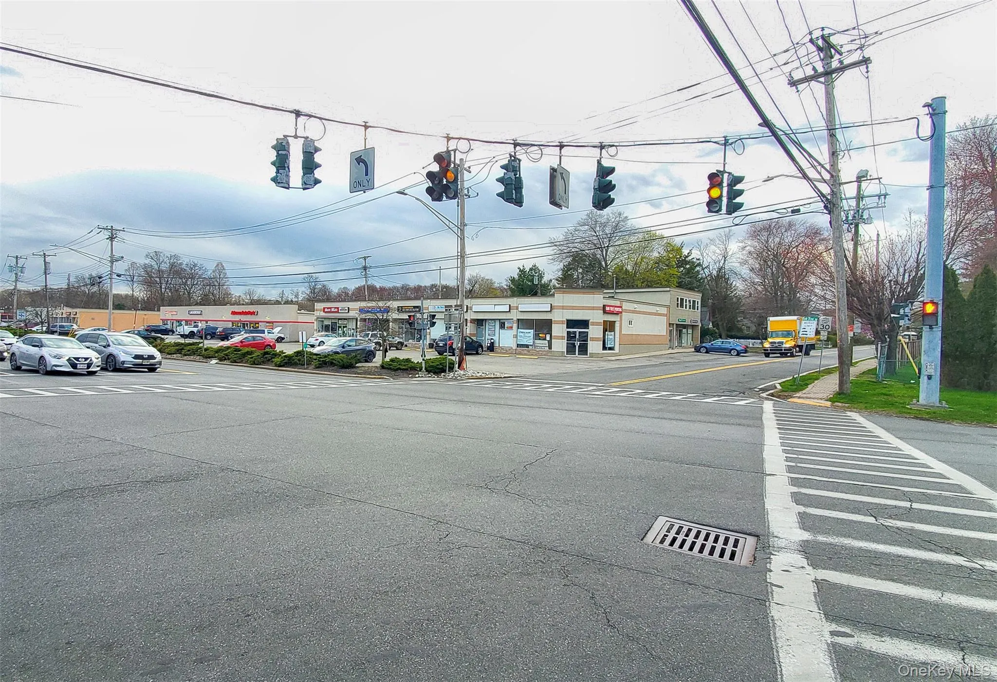 View of asphalt street featuring traffic lights View of asphalt street featuring traffic lights