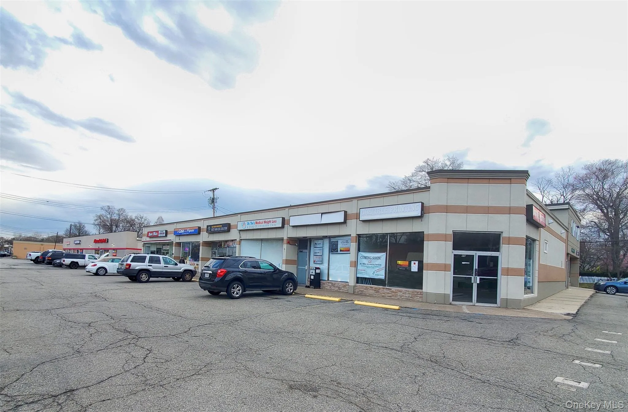 View of property with uncovered parking View of property with uncovered parking