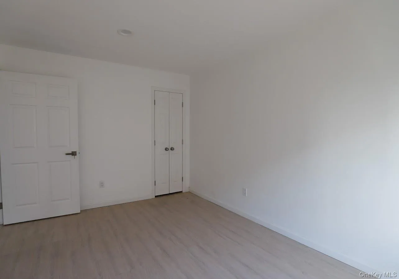 Spare room featuring light wood finished floors and baseboards Spare room featuring light wood finished floors and baseboards