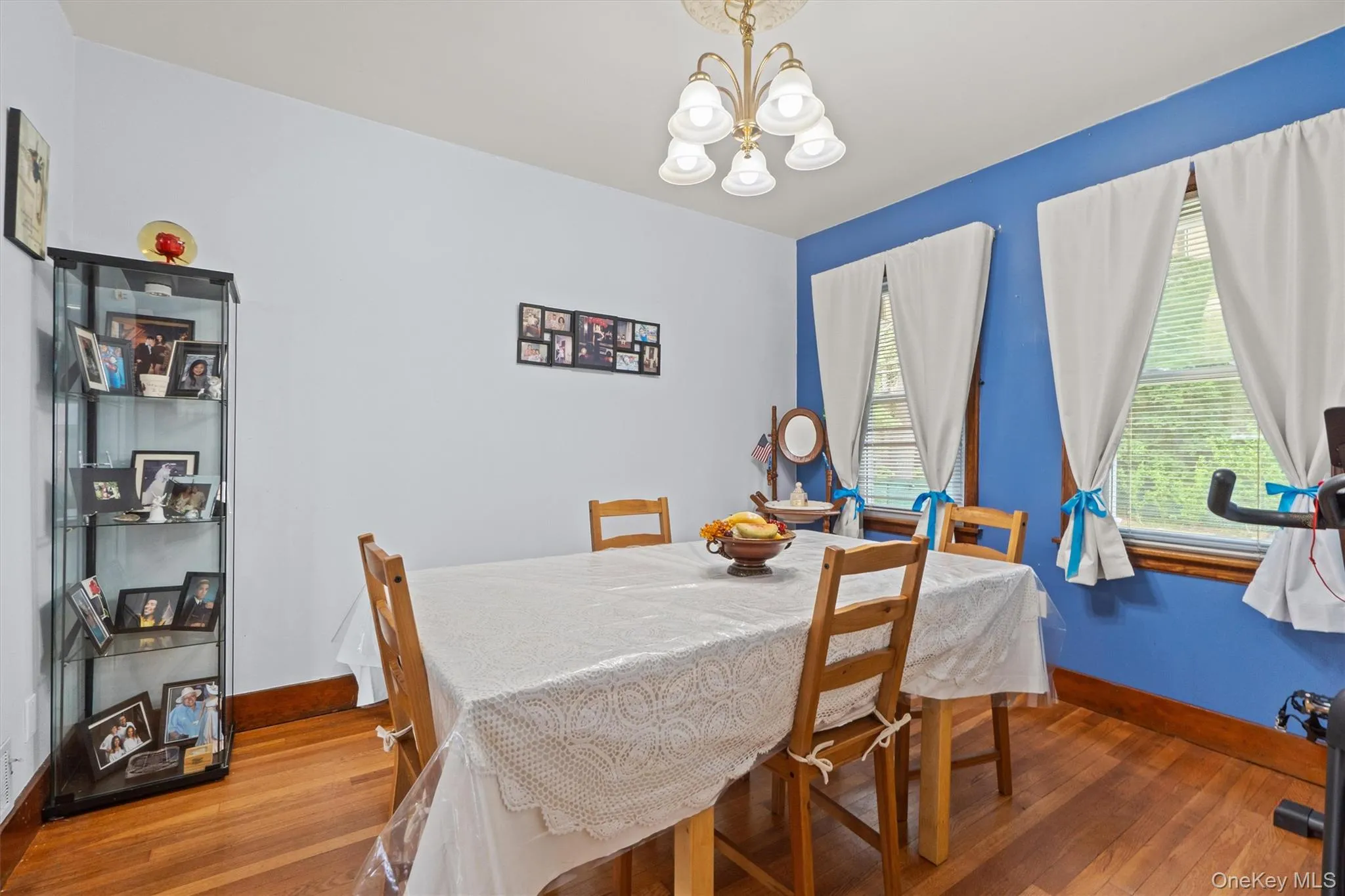 Dining room with a chandelier, light wood finished floors. Dining room with a chandelier, light wood finished floors.