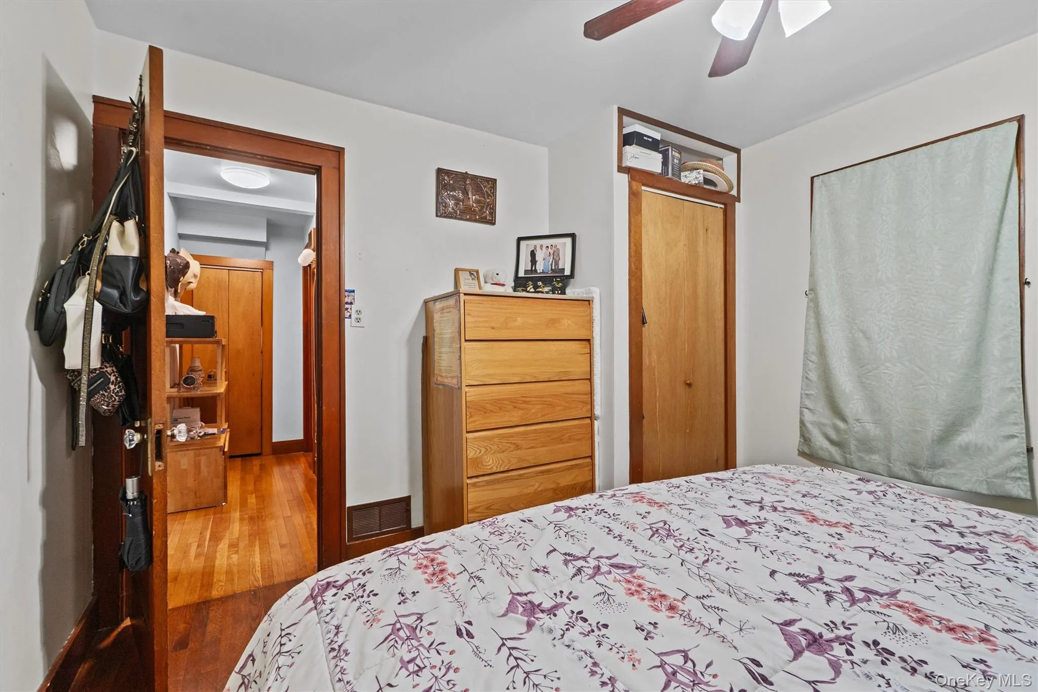 Bedroom with wood-type flooring, and a ceiling fan. Bedroom with wood-type flooring, and a ceiling fan.