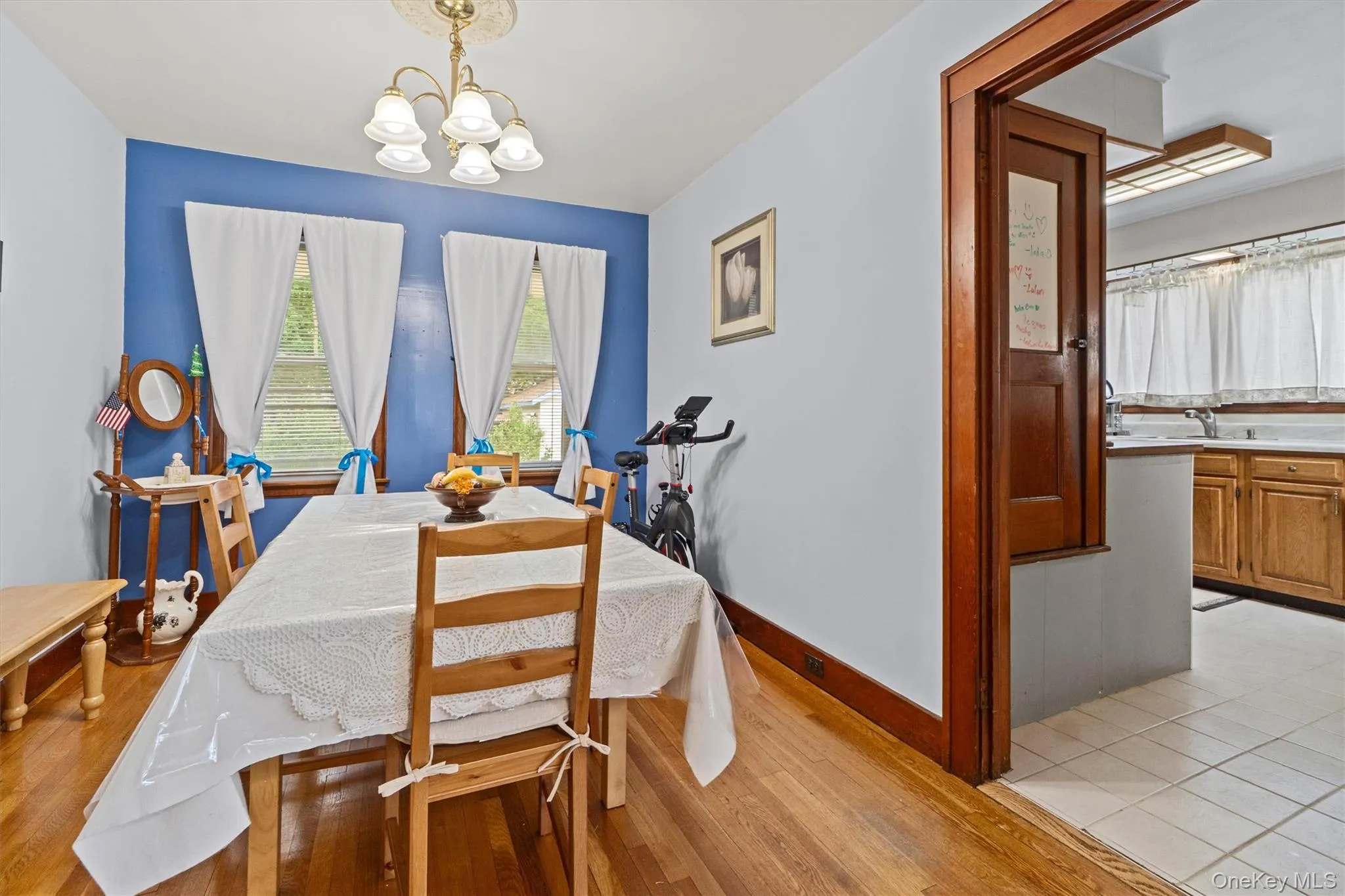 Dining room with a chandelier, light wood finished floors. Dining room with a chandelier, light wood finished floors.
