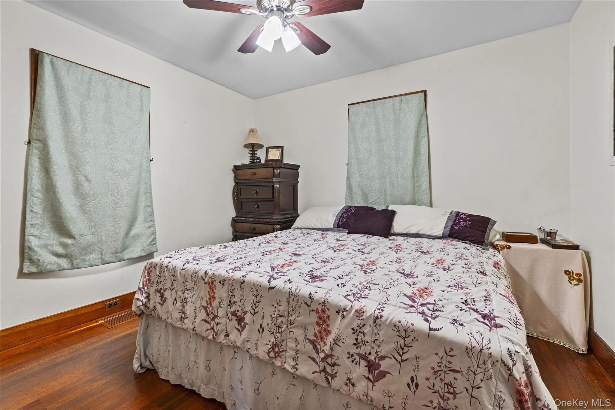 Bedroom with wood-type flooring, and a ceiling fan. Bedroom with wood-type flooring, and a ceiling fan.