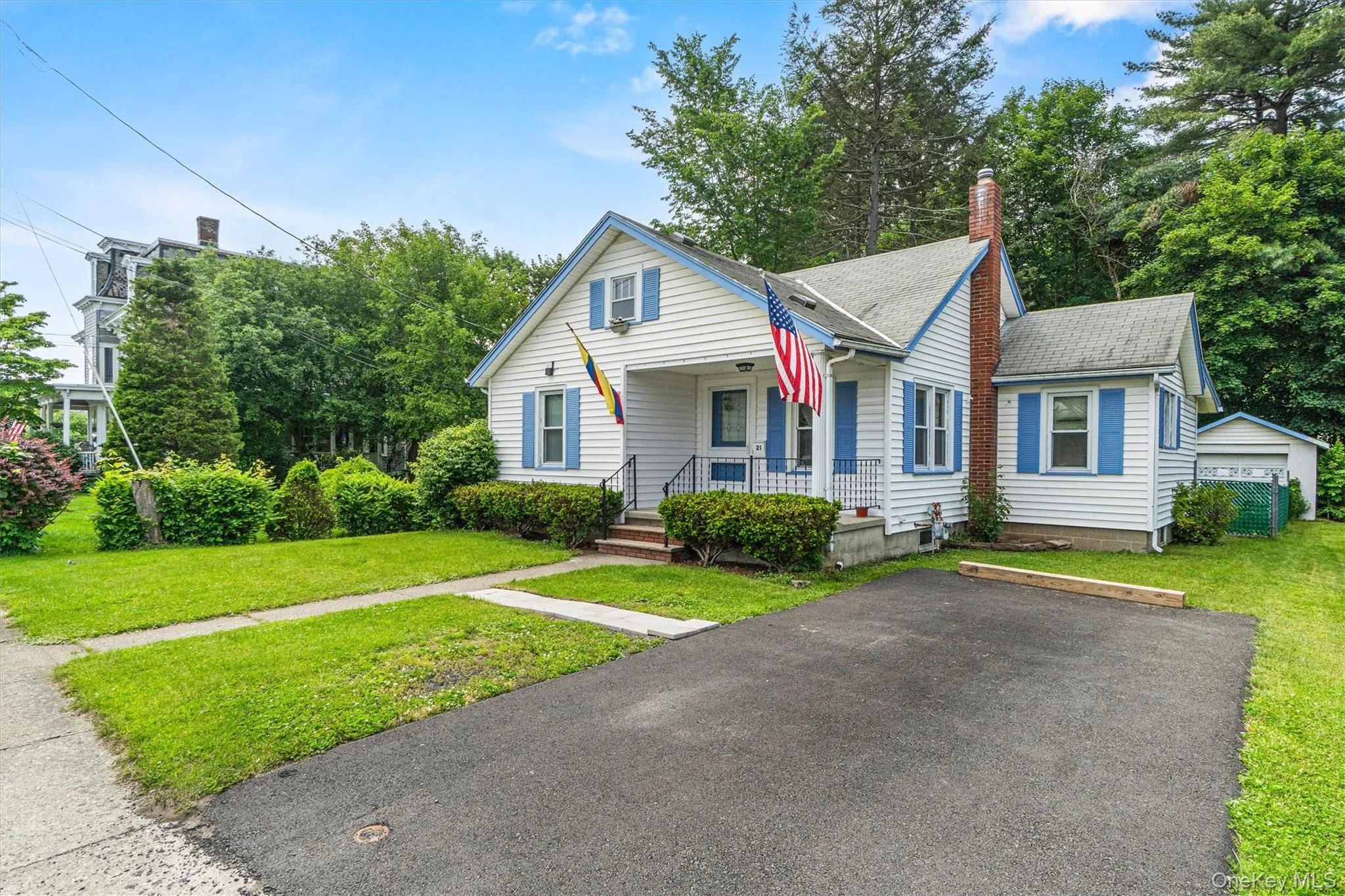 Bungalow with covered porch, a chimney, a front yard, and roof with shingles Bungalow with covered porch, a chimney, a front yard, and roof with shingles
