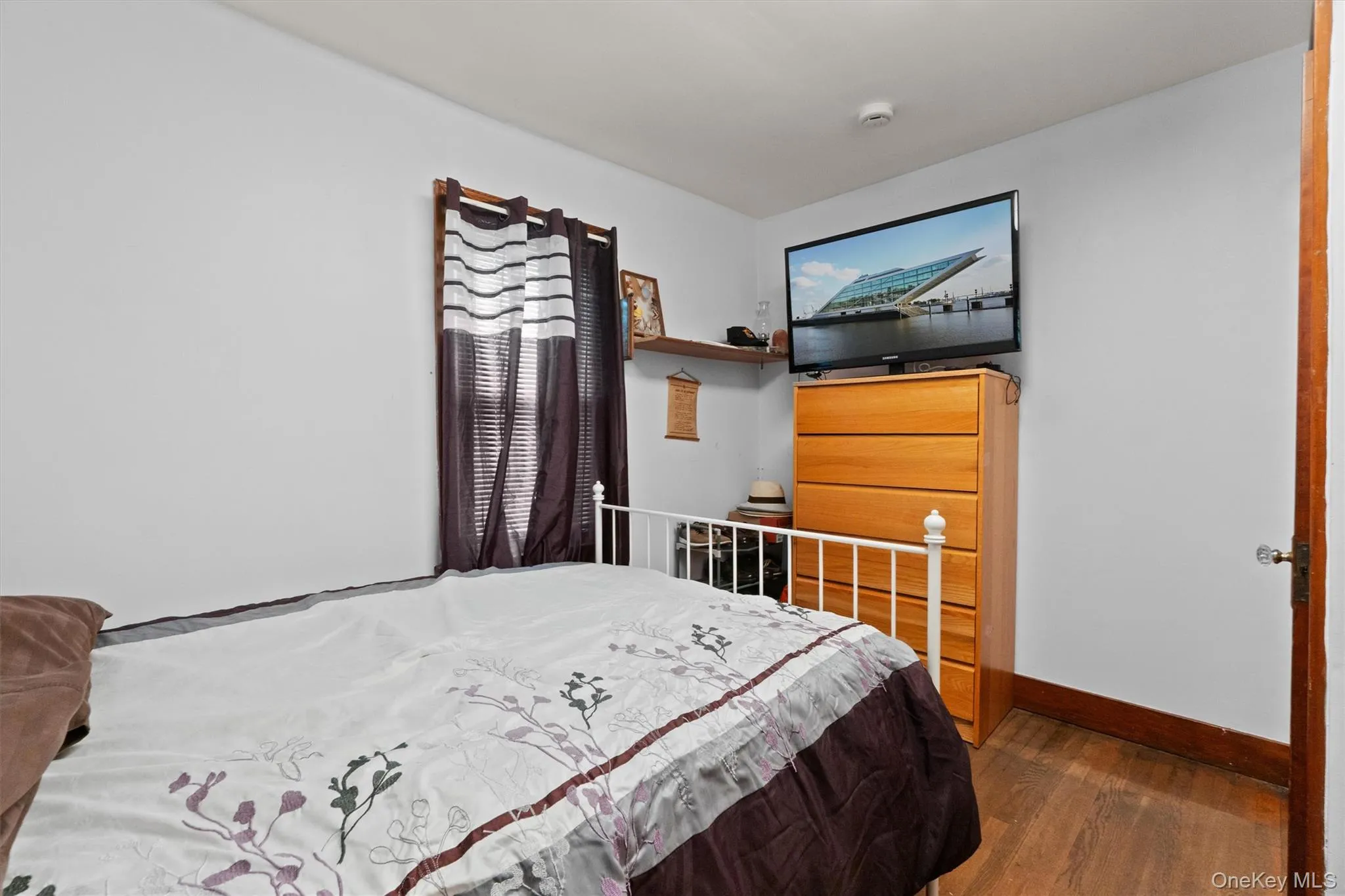 Bedroom featuring wood finished floors. Bedroom featuring wood finished floors.