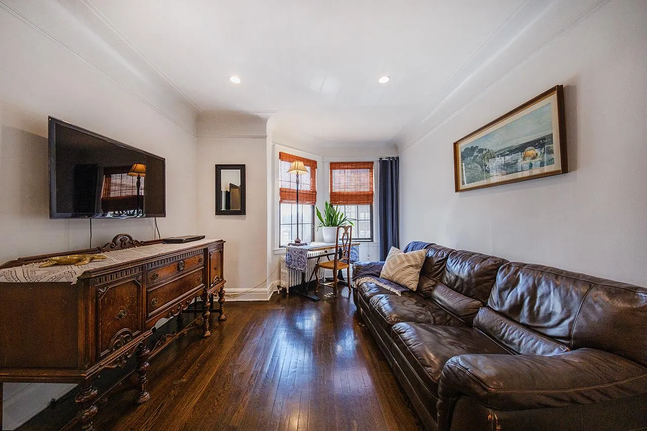 Living area featuring wood finished floors, crown molding, baseboards, and recessed lighting Living area featuring wood finished floors, crown molding, baseboards, and recessed lighting