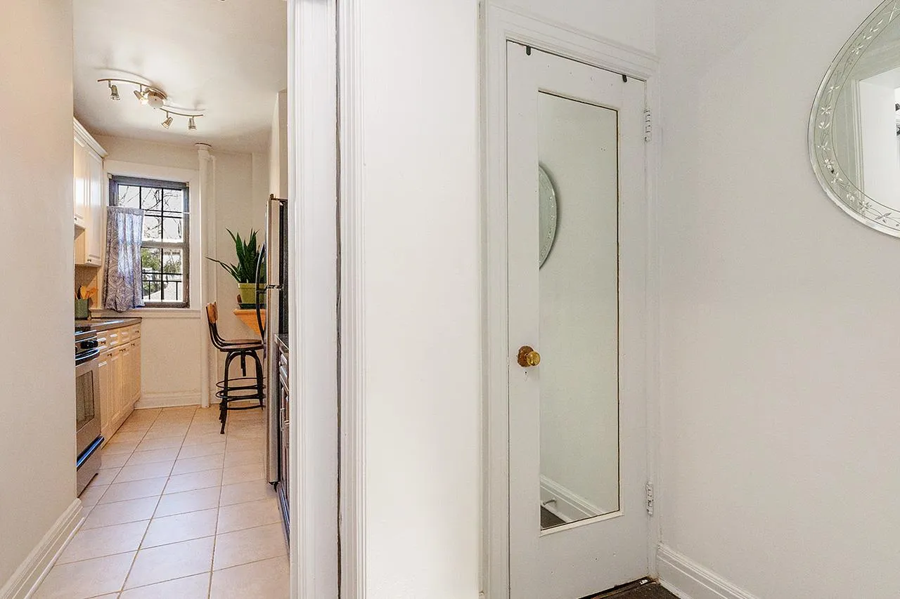 Hallway featuring light tile patterned floors and baseboards Hallway featuring light tile patterned floors and baseboards