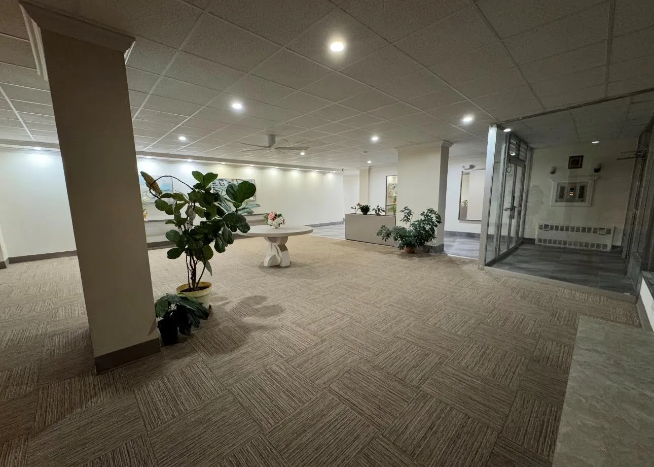 Building lobby with a paneled ceiling and recessed lighting Building lobby with a paneled ceiling and recessed lighting