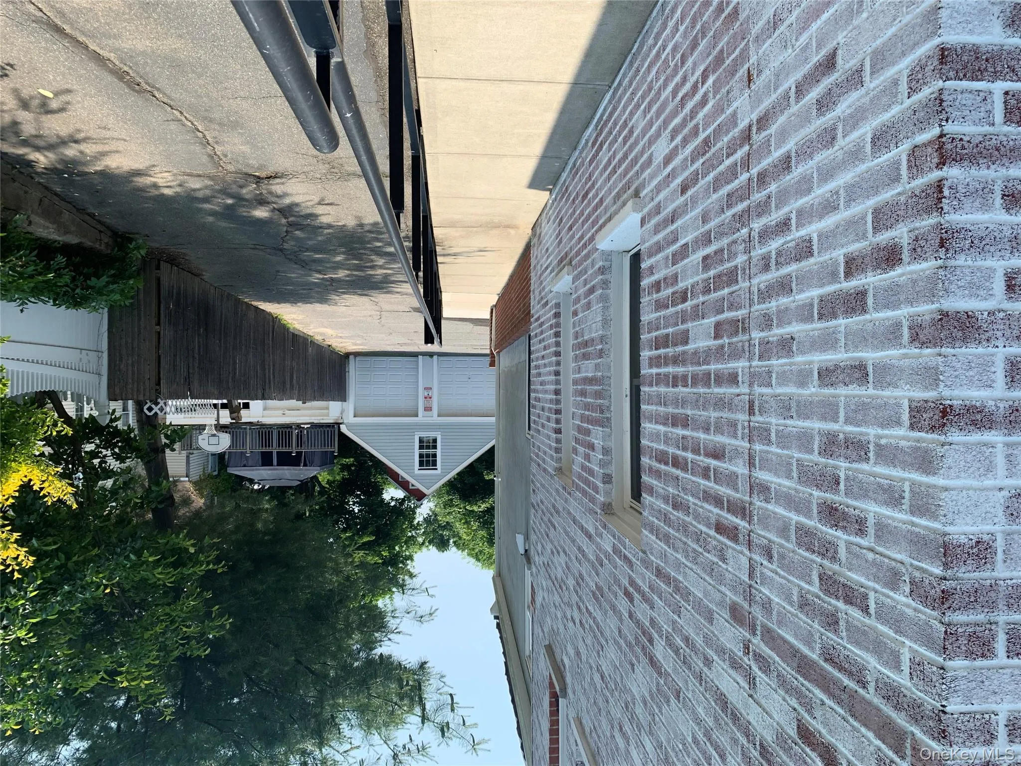 View of property exterior featuring brick siding, a garage, and an outbuilding View of property exterior featuring brick siding, a garage, and an outbuilding