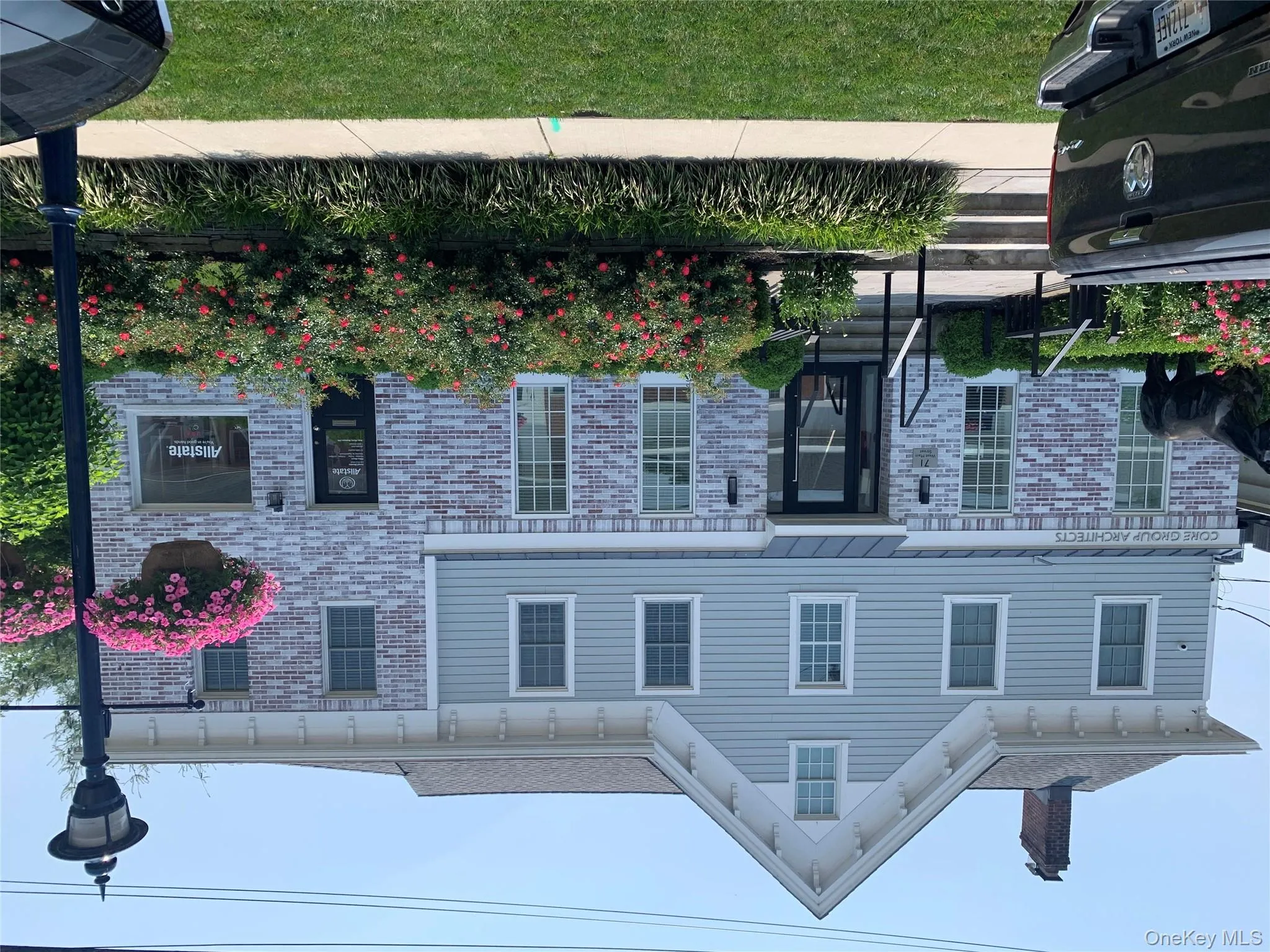 Italianate home featuring brick siding, a chimney, and a front yard Italianate home featuring brick siding, a chimney, and a front yard