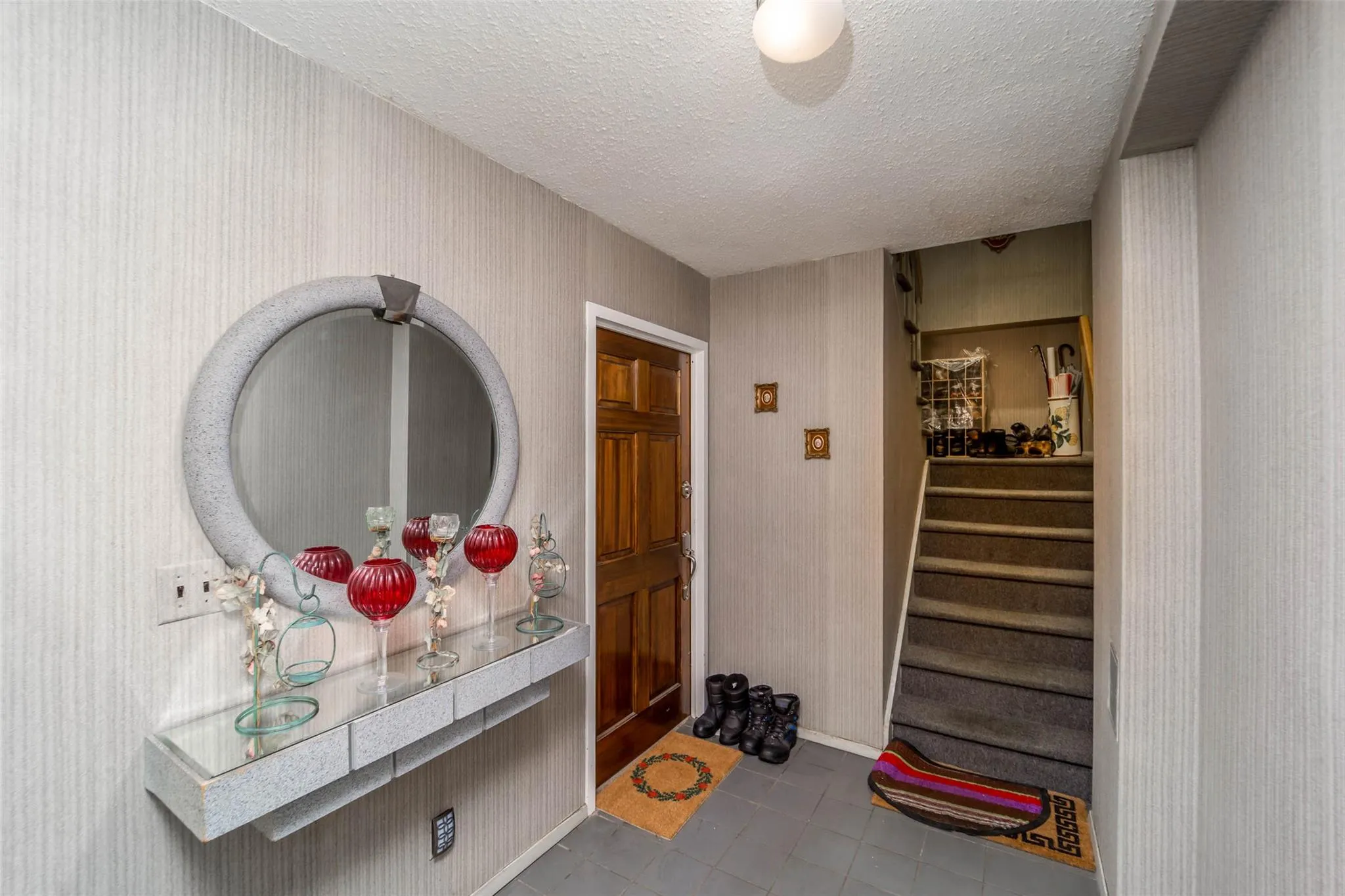 Tiled foyer with a textured ceiling and stairway Tiled foyer with a textured ceiling and stairway