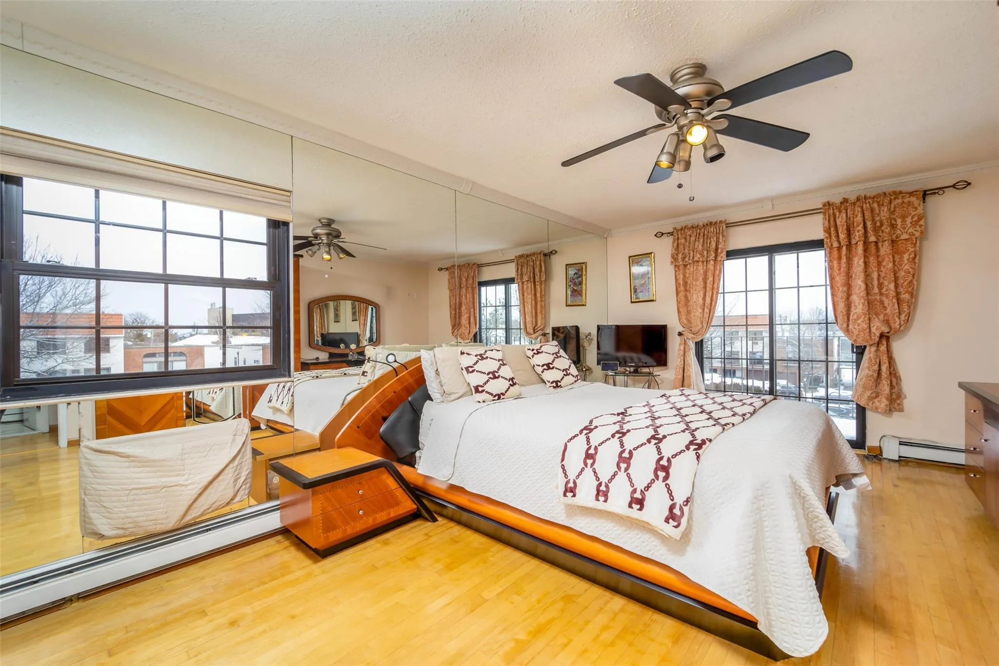 Bedroom featuring a baseboard radiator and wood finished floors Bedroom featuring a baseboard radiator and wood finished floors