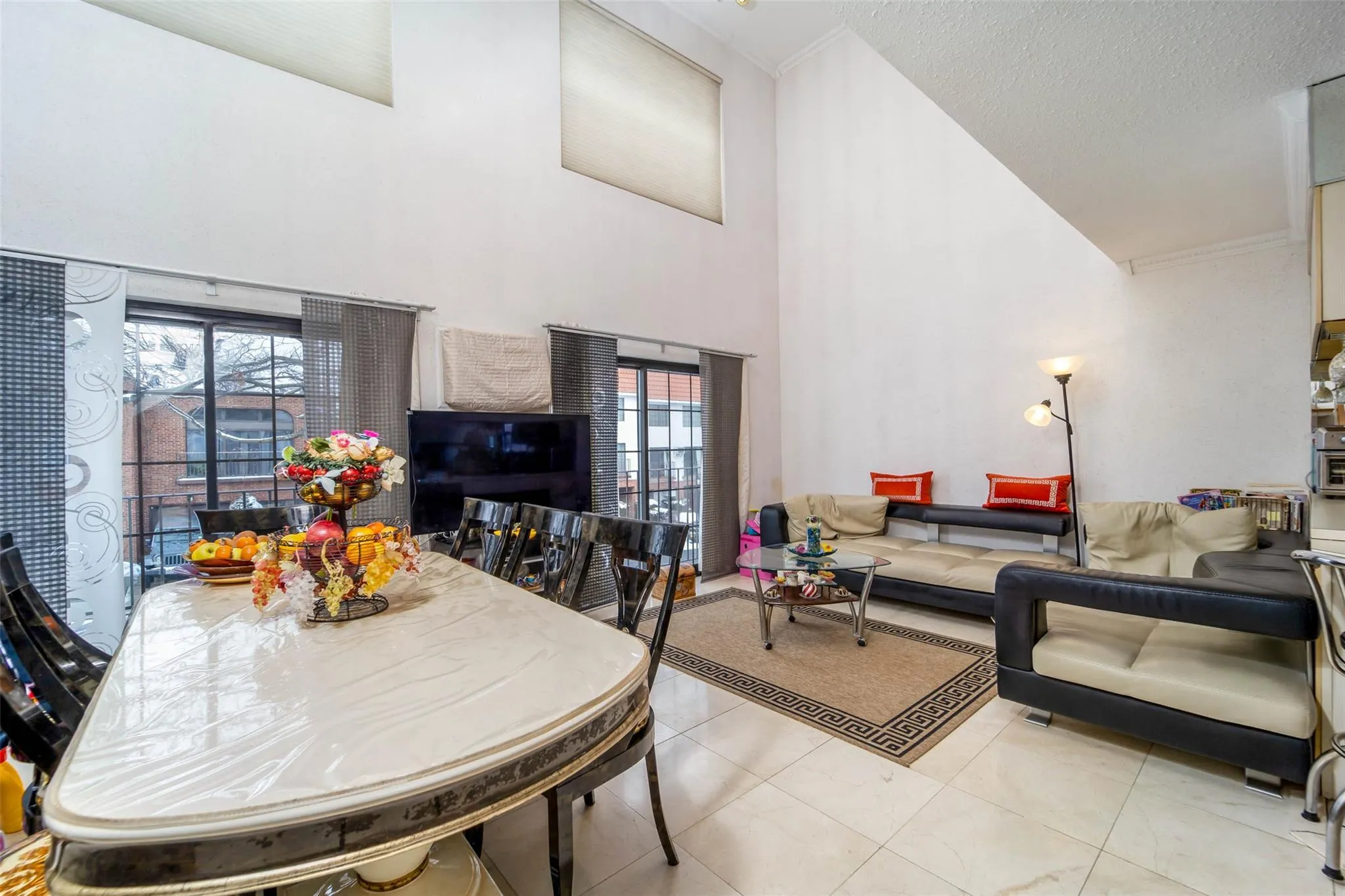 Dining area featuring a towering ceiling and tile patterned floors Dining area featuring a towering ceiling and tile patterned floors