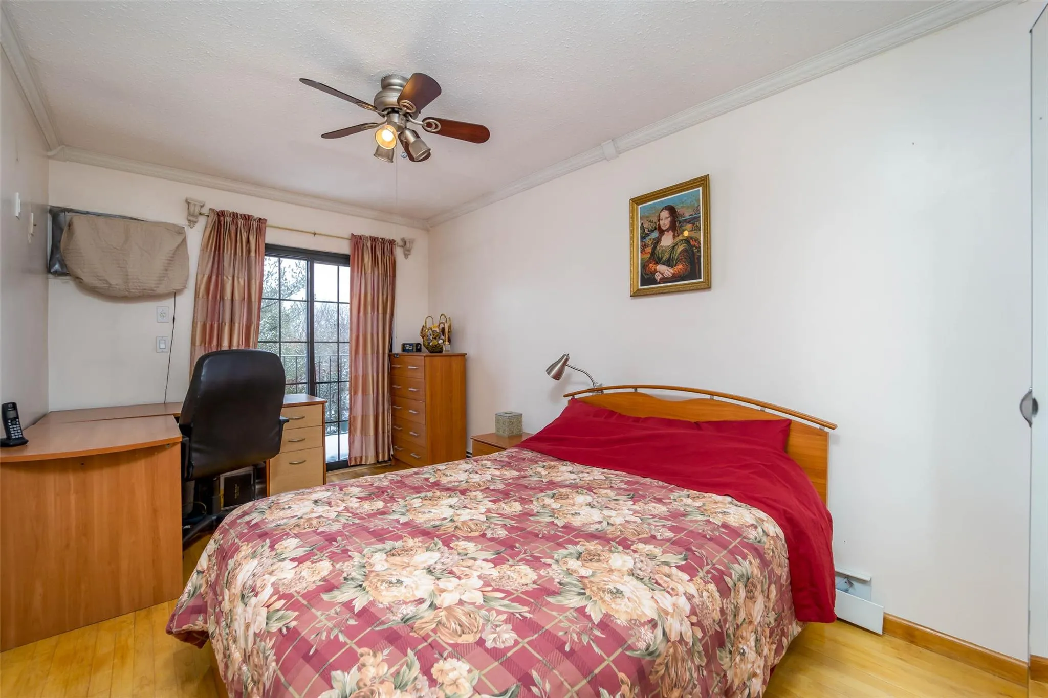 Bedroom featuring wood finished floors, crown molding, an office area, a ceiling fan, and baseboards Bedroom featuring wood finished floors, crown molding, an office area, a ceiling fan, and baseboards