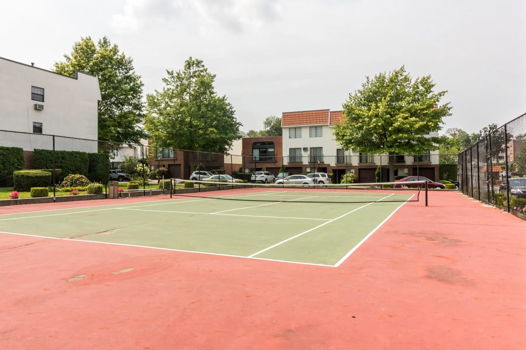 View of tennis court featuring community basketball court View of tennis court featuring community basketball court