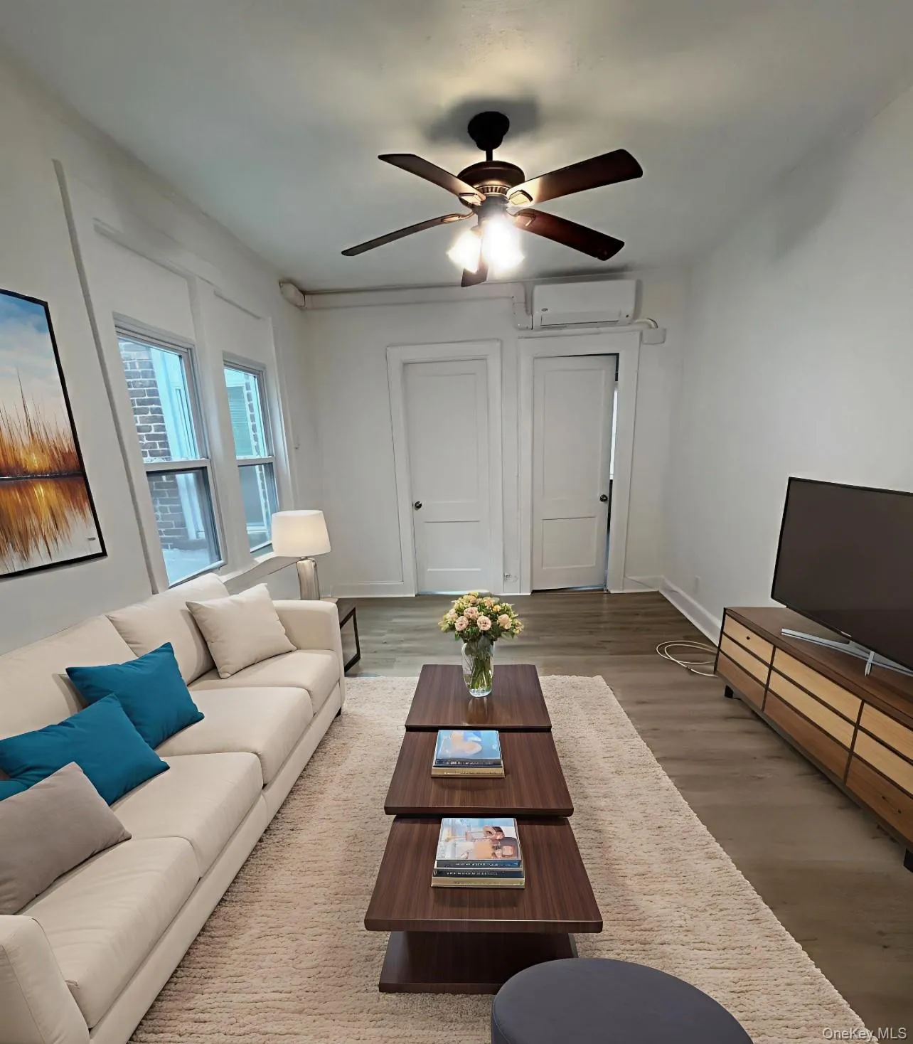 Living area with wood finished floors and ceiling fan Living area with wood finished floors and ceiling fan