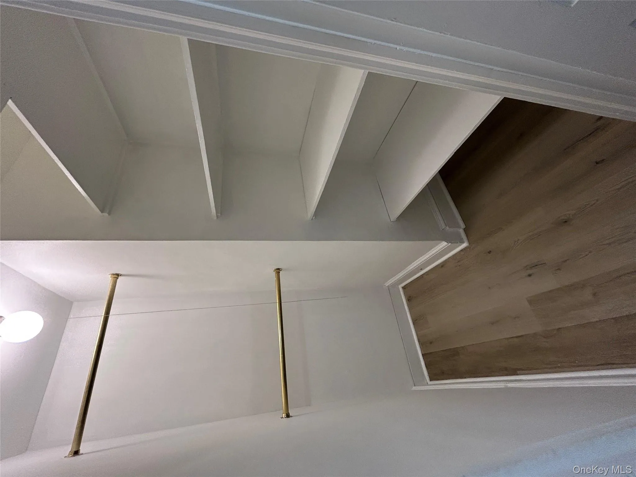 Walk in closet with light wood-type flooring Walk in closet with light wood-type flooring