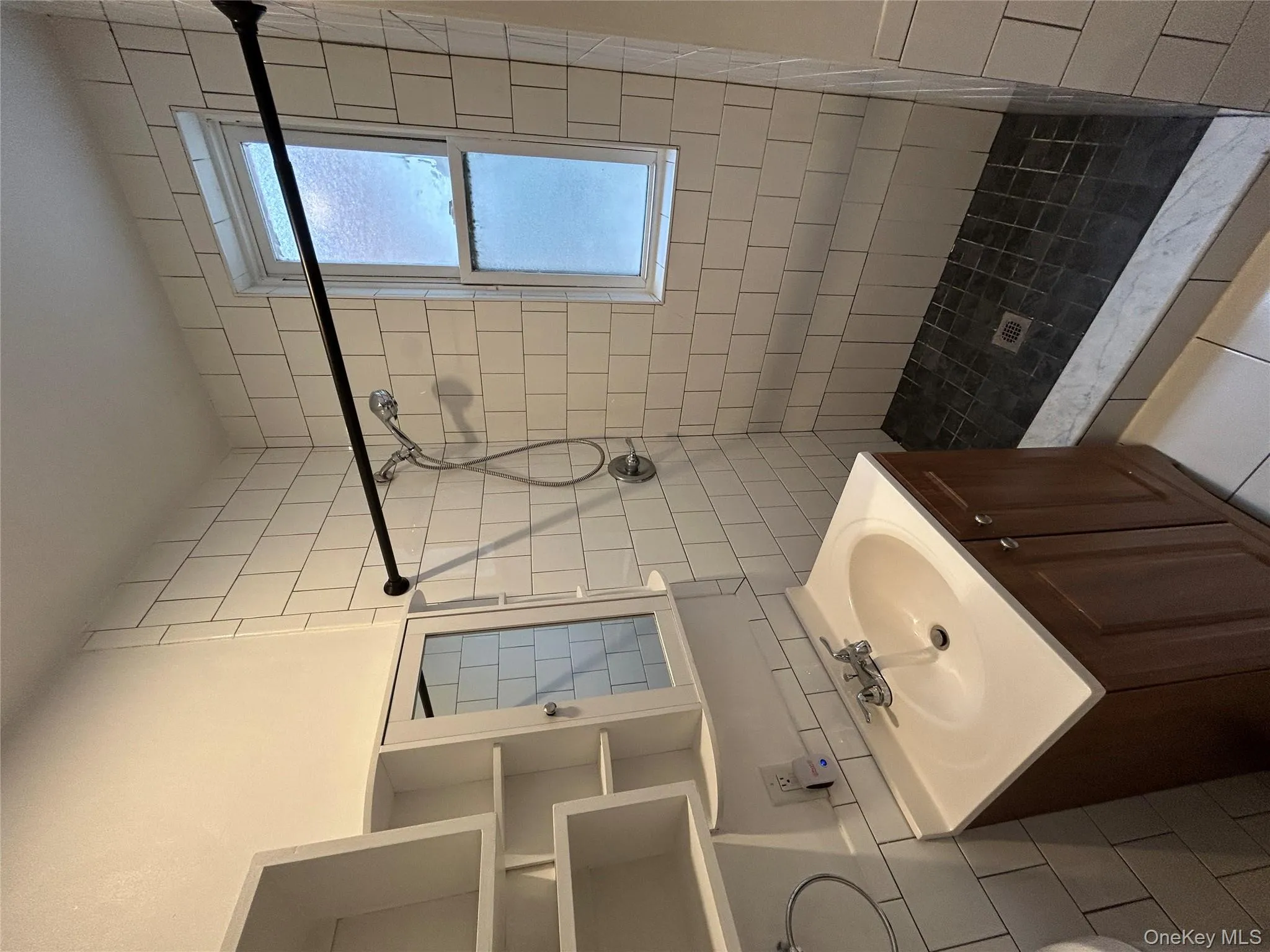 Full bathroom featuring vanity, a stall shower, and light tile patterned floors Full bathroom featuring vanity, a stall shower, and light tile patterned floors