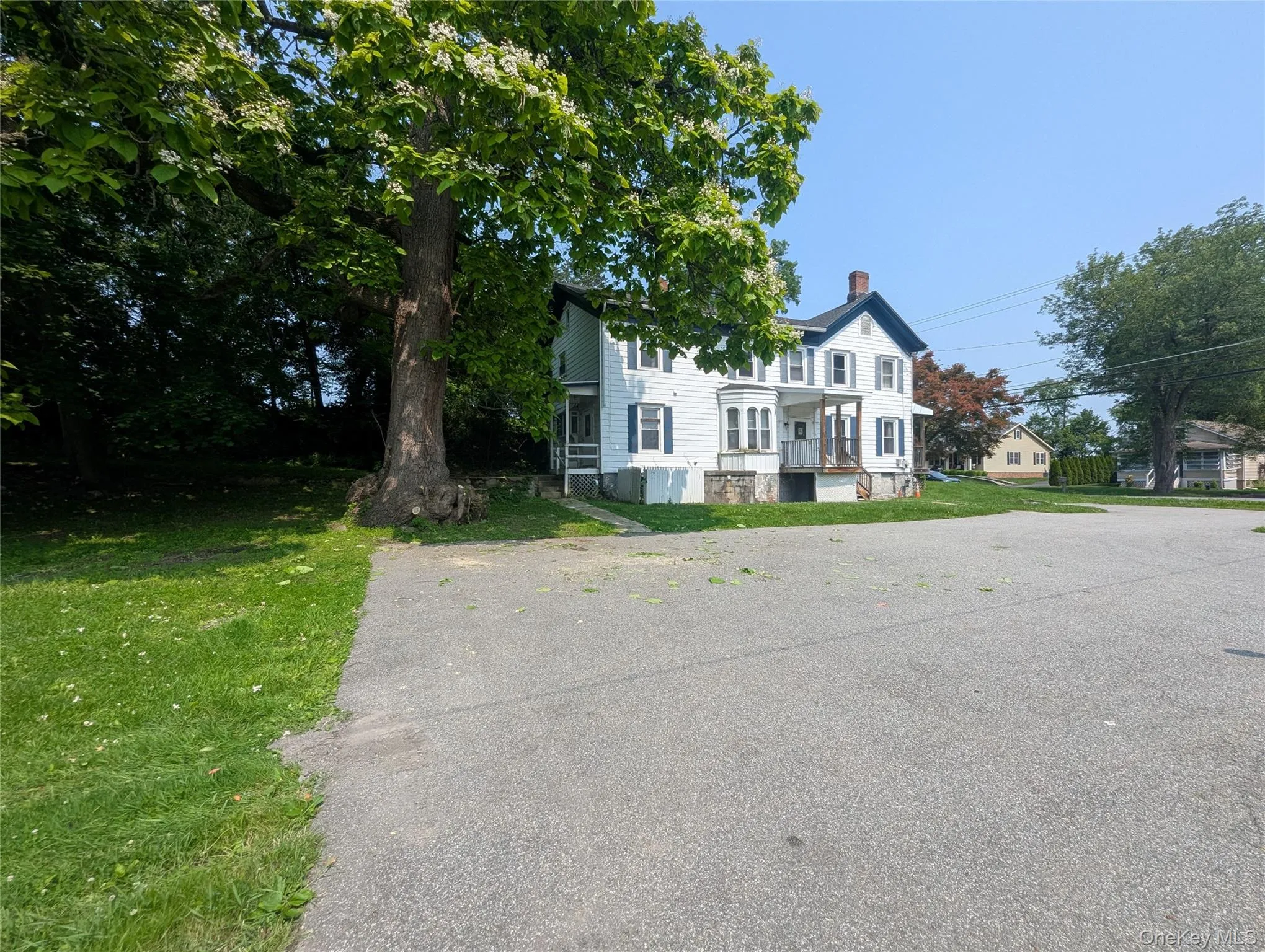 Multi unit property with a chimney and a front yard Multi unit property with a chimney and a front yard