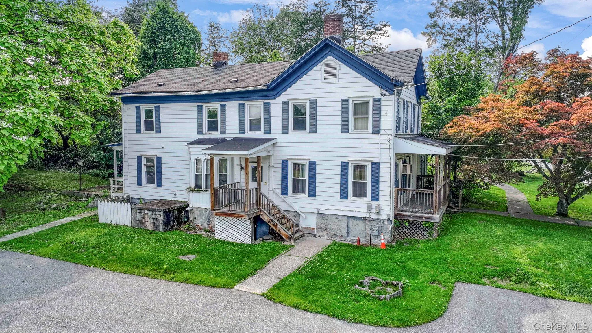 View of front of home featuring a chimney, a front yard, and roof with shingles View of front of home featuring a chimney, a front yard, and roof with shingles