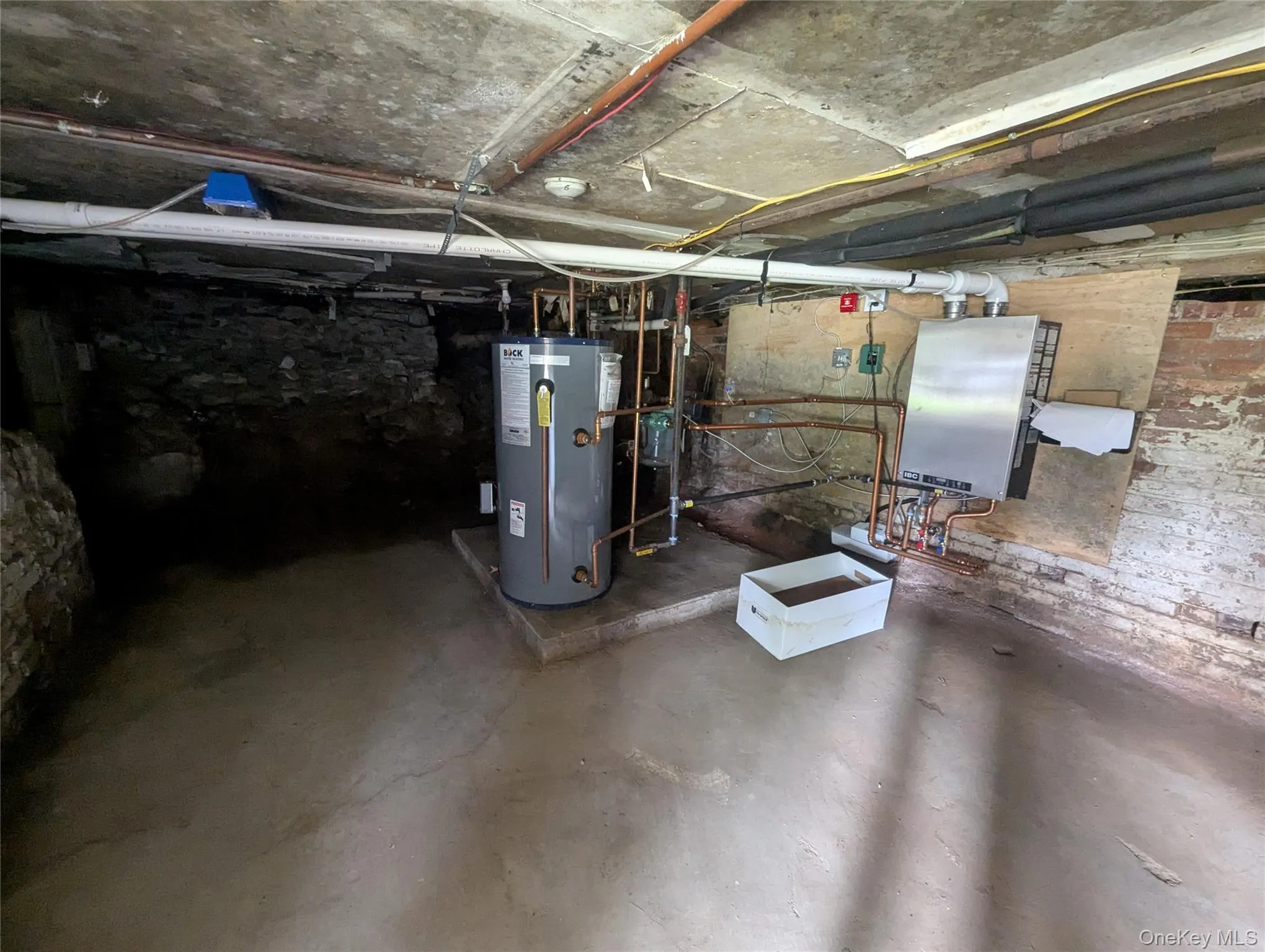 Unfinished below grade area with gas water heater and heating unit Unfinished below grade area with gas water heater and heating unit