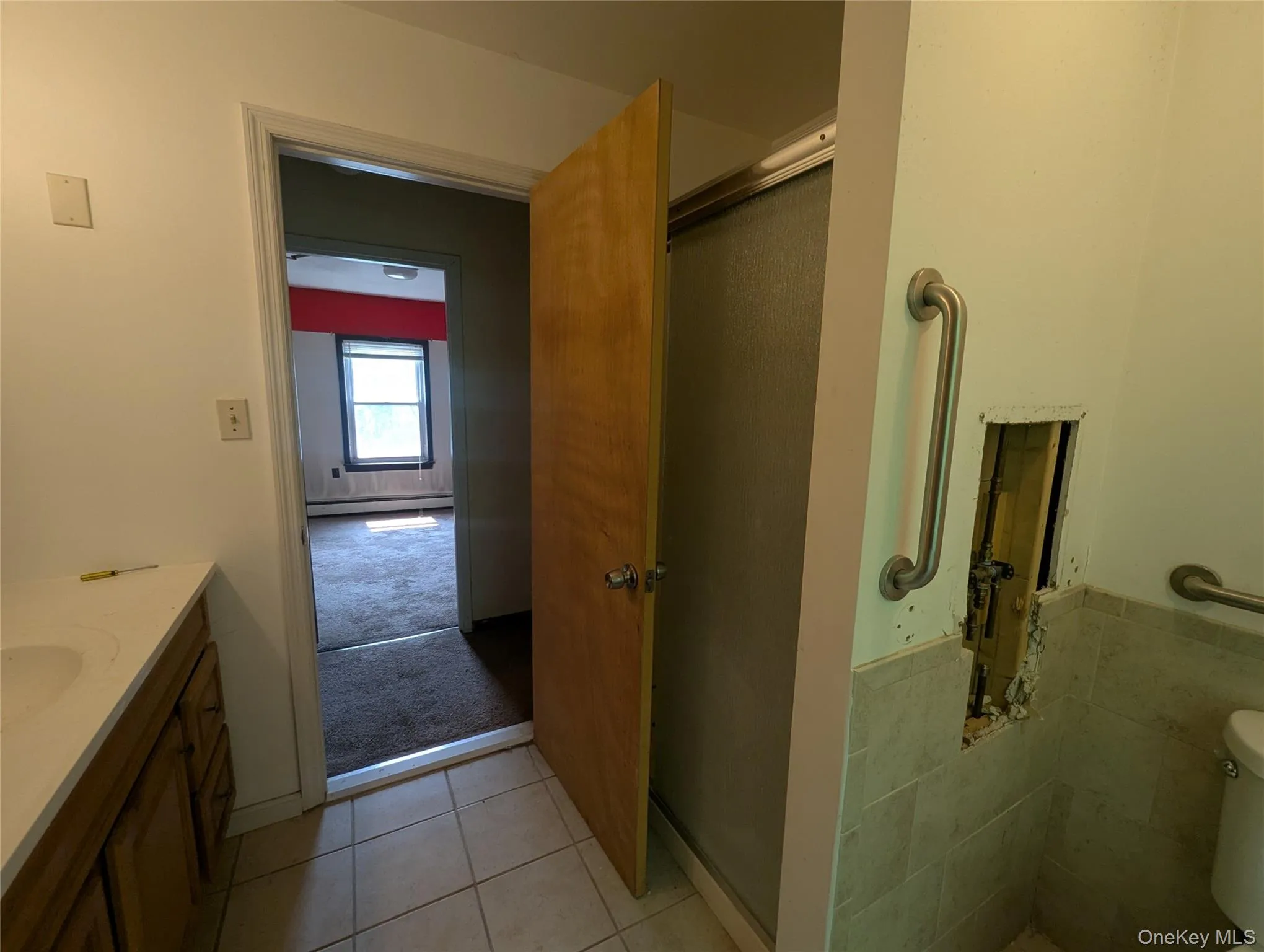 Full bath with tile patterned floors, a shower with shower door, and vanity Full bath with tile patterned floors, a shower with shower door, and vanity