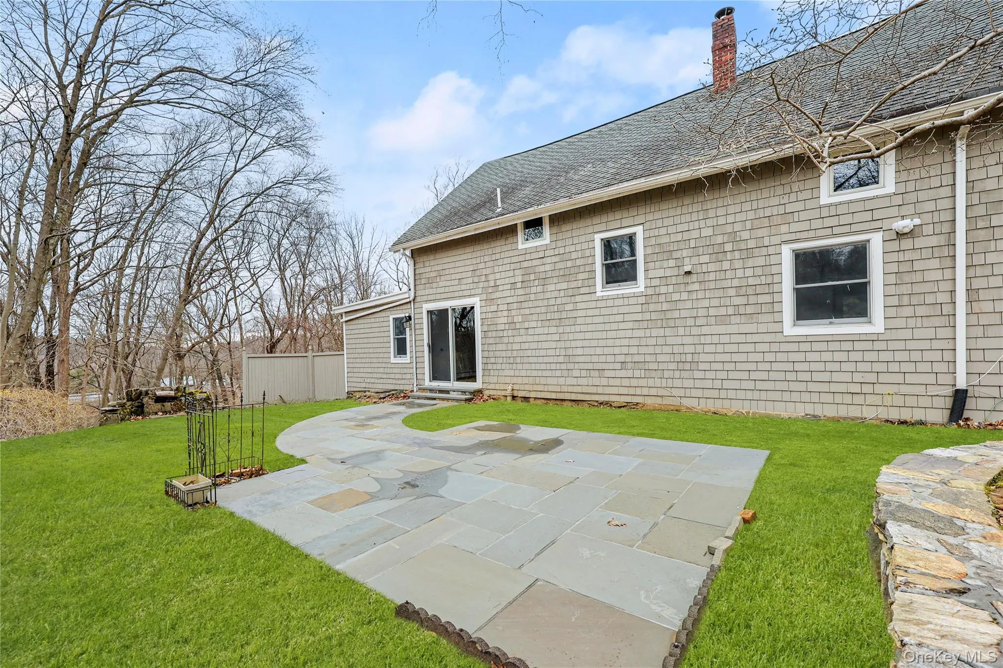 Rear view of house featuring the yard, and a patio Rear view of house featuring the yard, and a patio