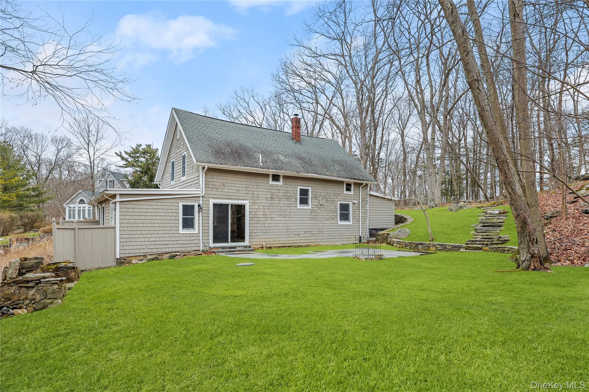 Back of house , lawn, entry steps, and a patio Back of house , lawn, entry steps, and a patio
