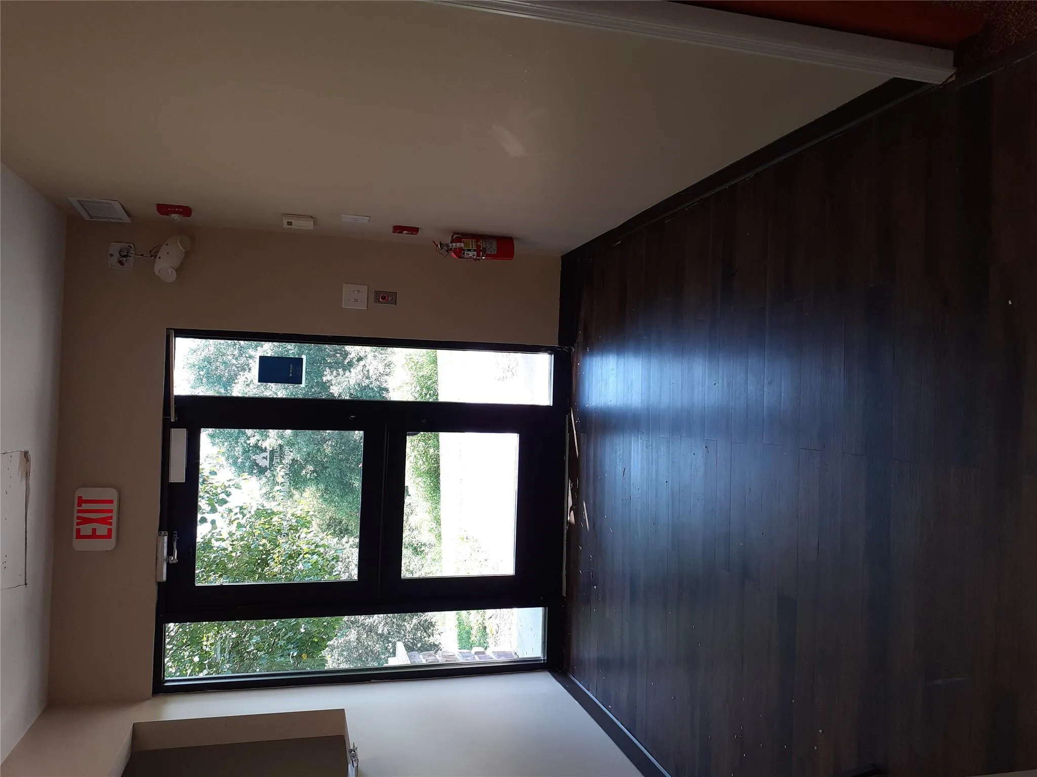 Unfurnished room featuring dark wood-style flooring and baseboards Unfurnished room featuring dark wood-style flooring and baseboards