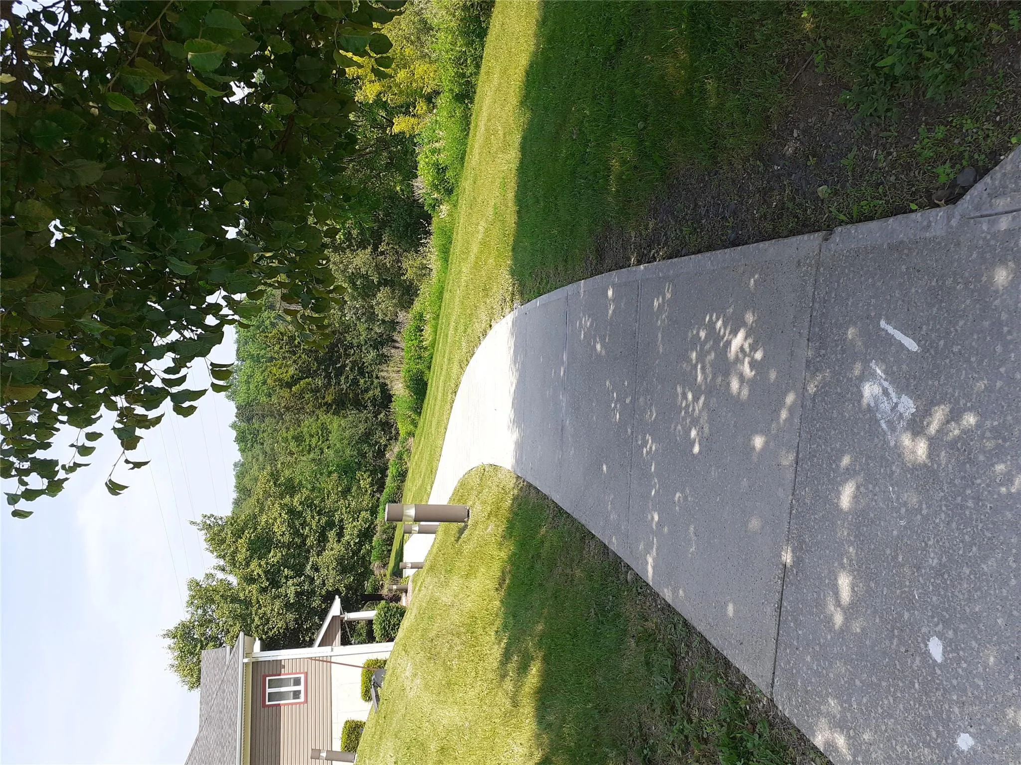 View of property's community with a lawn View of property's community with a lawn