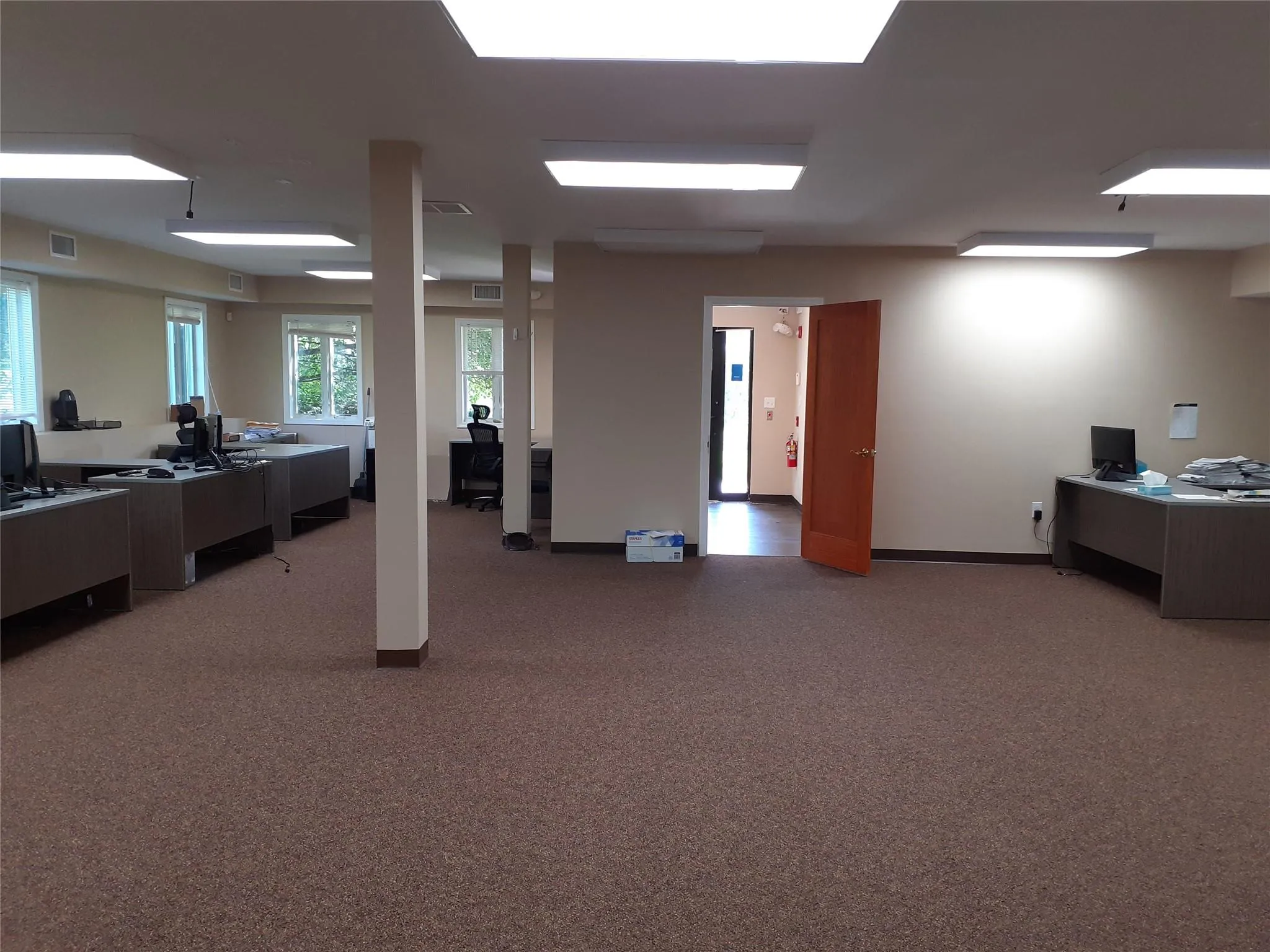 Home office with light carpet and baseboards Home office with light carpet and baseboards