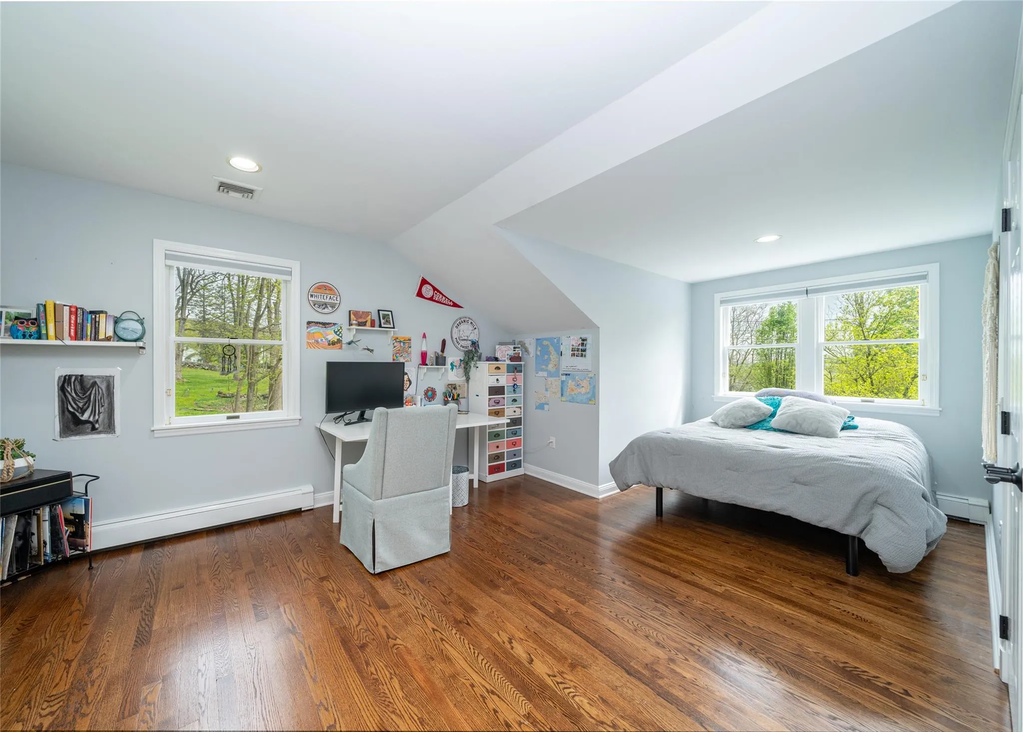 Bedroom featuring, multiple windows, and wood finished floors Bedroom featuring, multiple windows, and wood finished floors